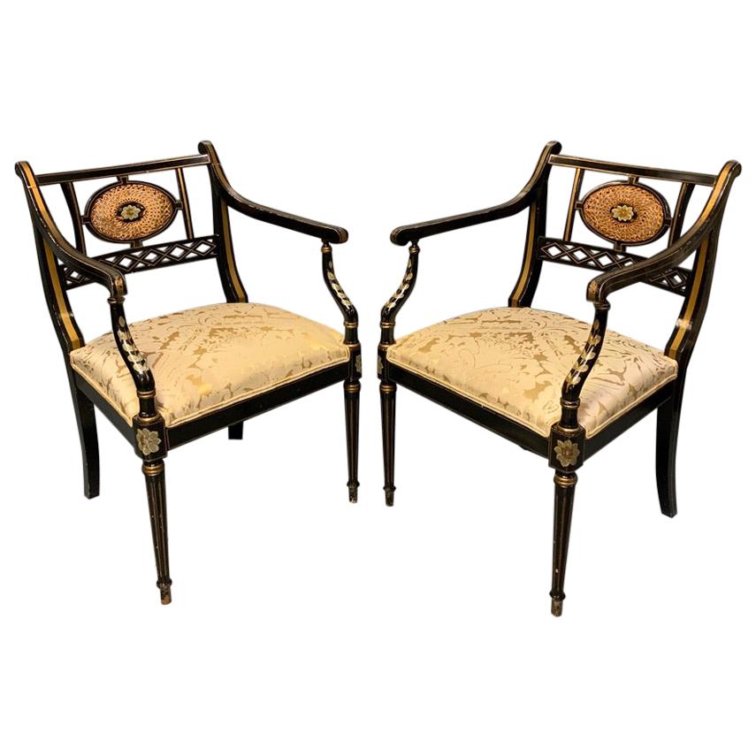 Pair of Edwardian Black Lacquered and Gilt Highlighted Elbow Chairs with Cane