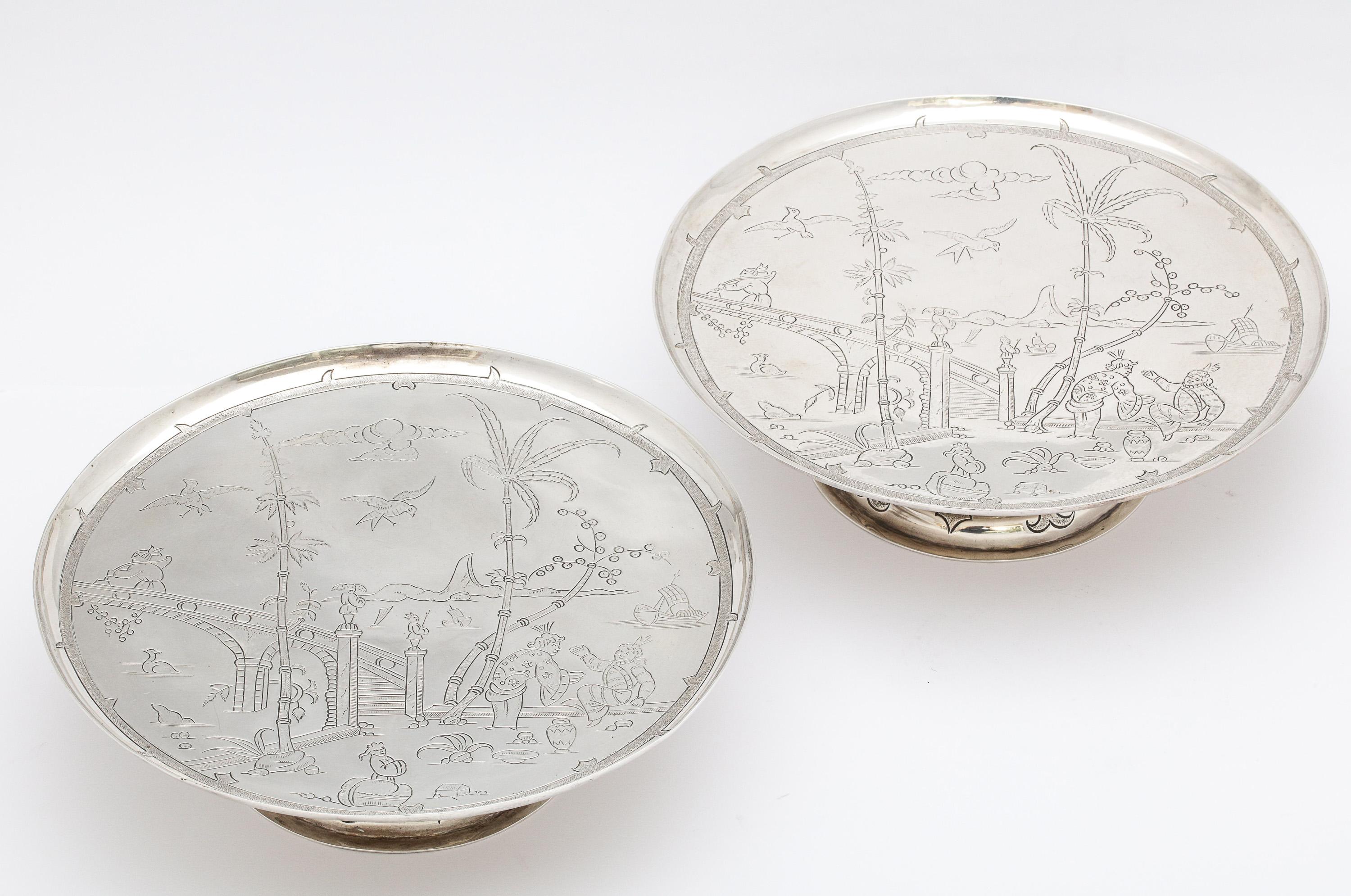 Pair of Edwardian period, sterling silver, Chinoiserie -Style pedestal-based tazas, London, 1913, Lionel Alfred Crichton - maker. Retailed at Crichton Bros., New York and London. Each cake stand measures 2 1/4 inches high x 7 3/4 inches in diameter