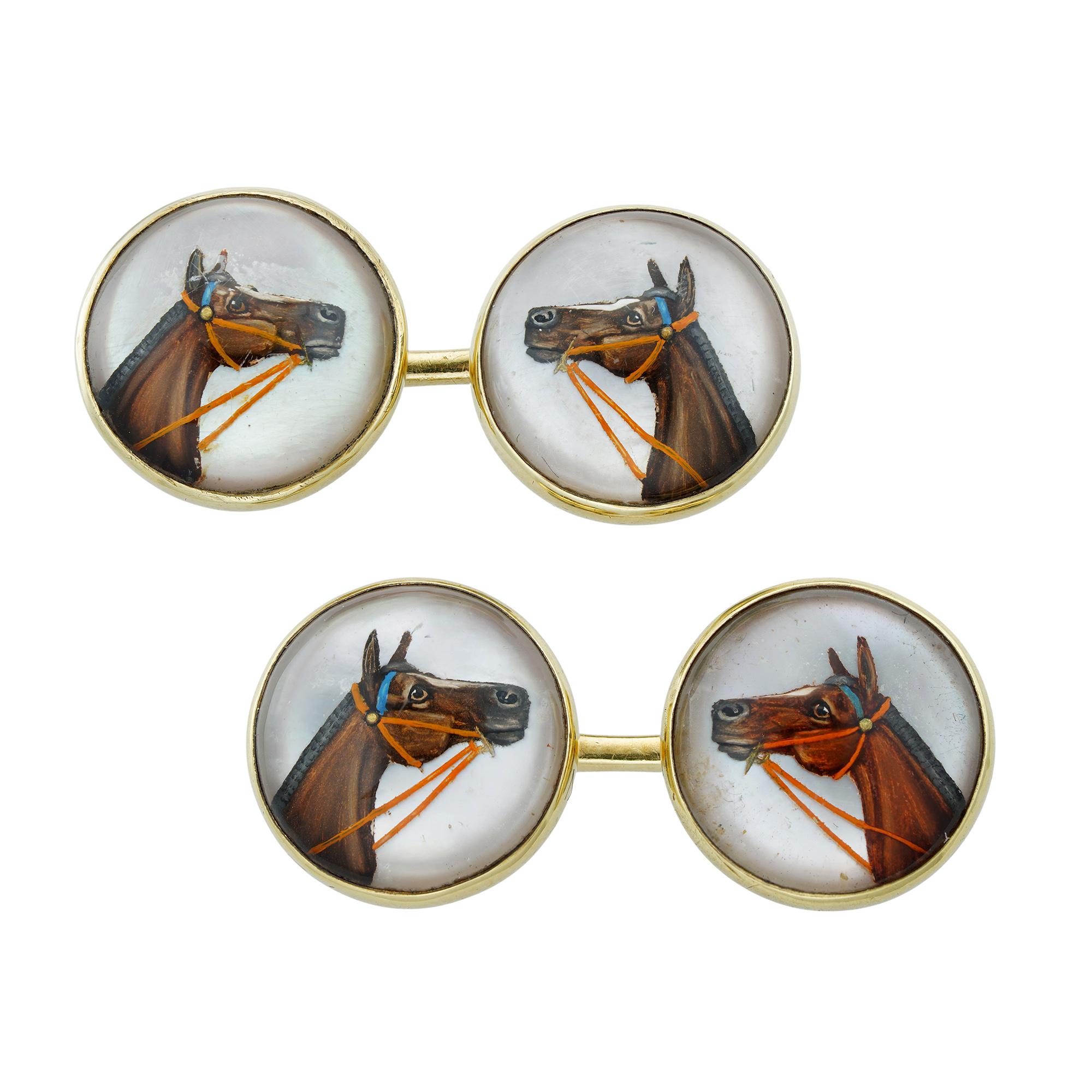 A pair of Edwardian reverse intaglio crystal cufflinks, the cabochon-cut crystal faces each engraved and painted on reverse with the profile image of a horse bust, to a mother-of-pearl background, each link measuring approximately 1.4cm in diameter,