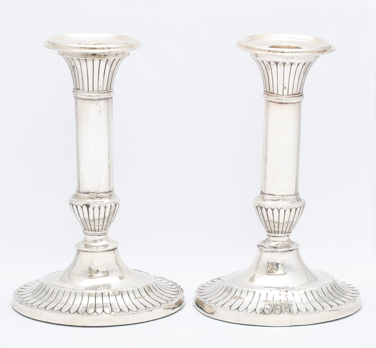 Pair of sterling silver George III-Style candlesticks, made in the Edwardian Period, Birmingham, England, year-hallmarked for 1912, Mappin and Webb - makers. Each candlestick measures 7 1/2 inches high x 4 3/4 inches wide (at widest point) x 3 3/4