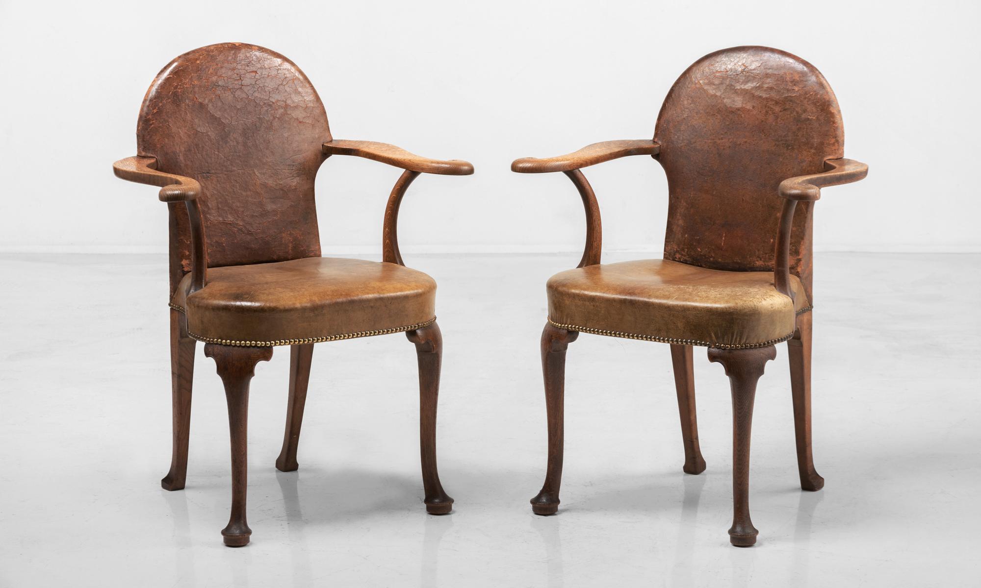 Pair of Edwardian oak and leather armchairs, England, circa 1900

Original leather upholstery, with open swept out arms on tall cabriole legs.