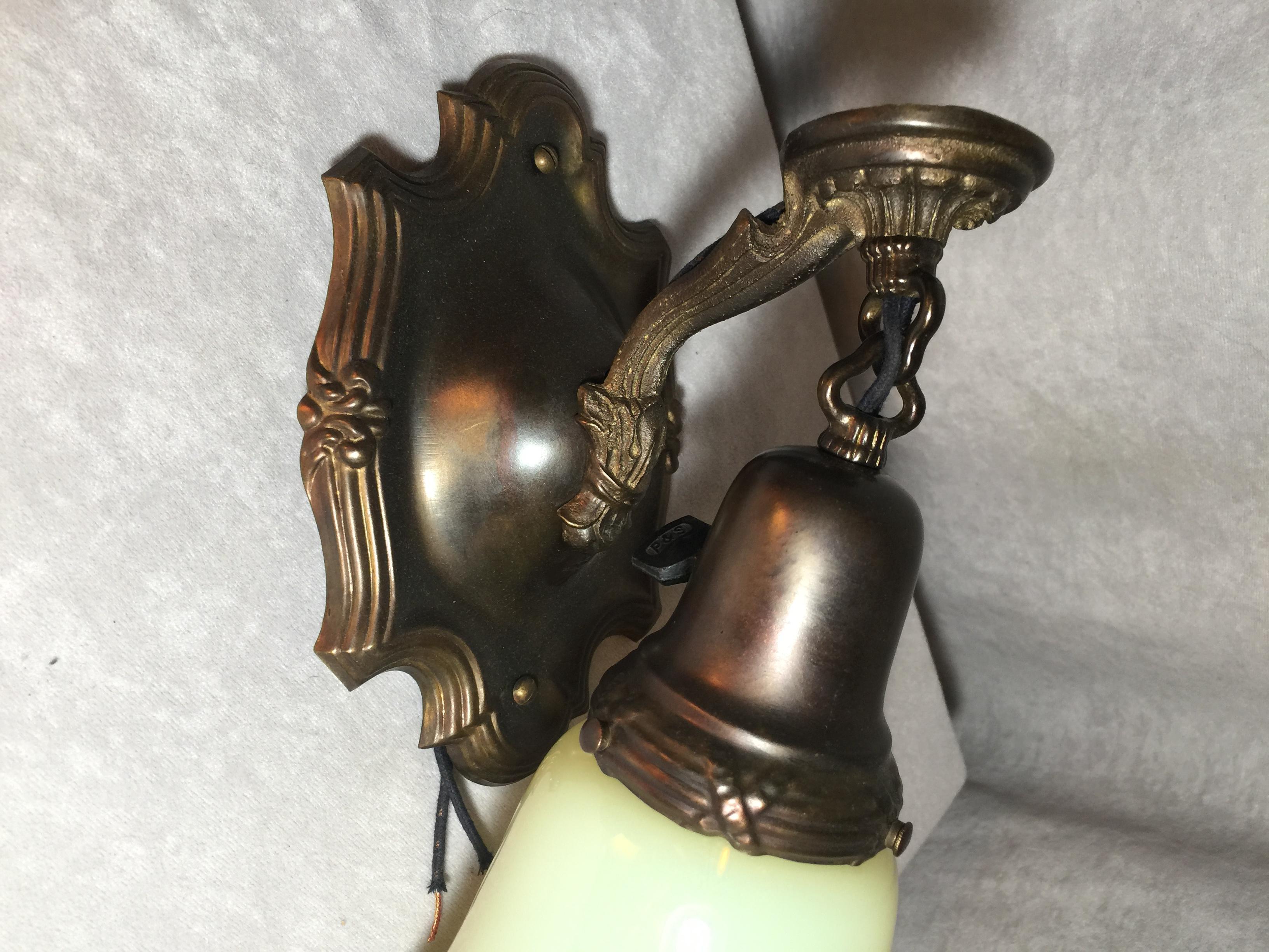 Offering a nice simple pair of Edwardian sconces in a rich deep brown patina with a pair of original period Vaseline glass shades. A nice package for any room. Newly wired and ready to hang. The price listed below is for the set, you get both for