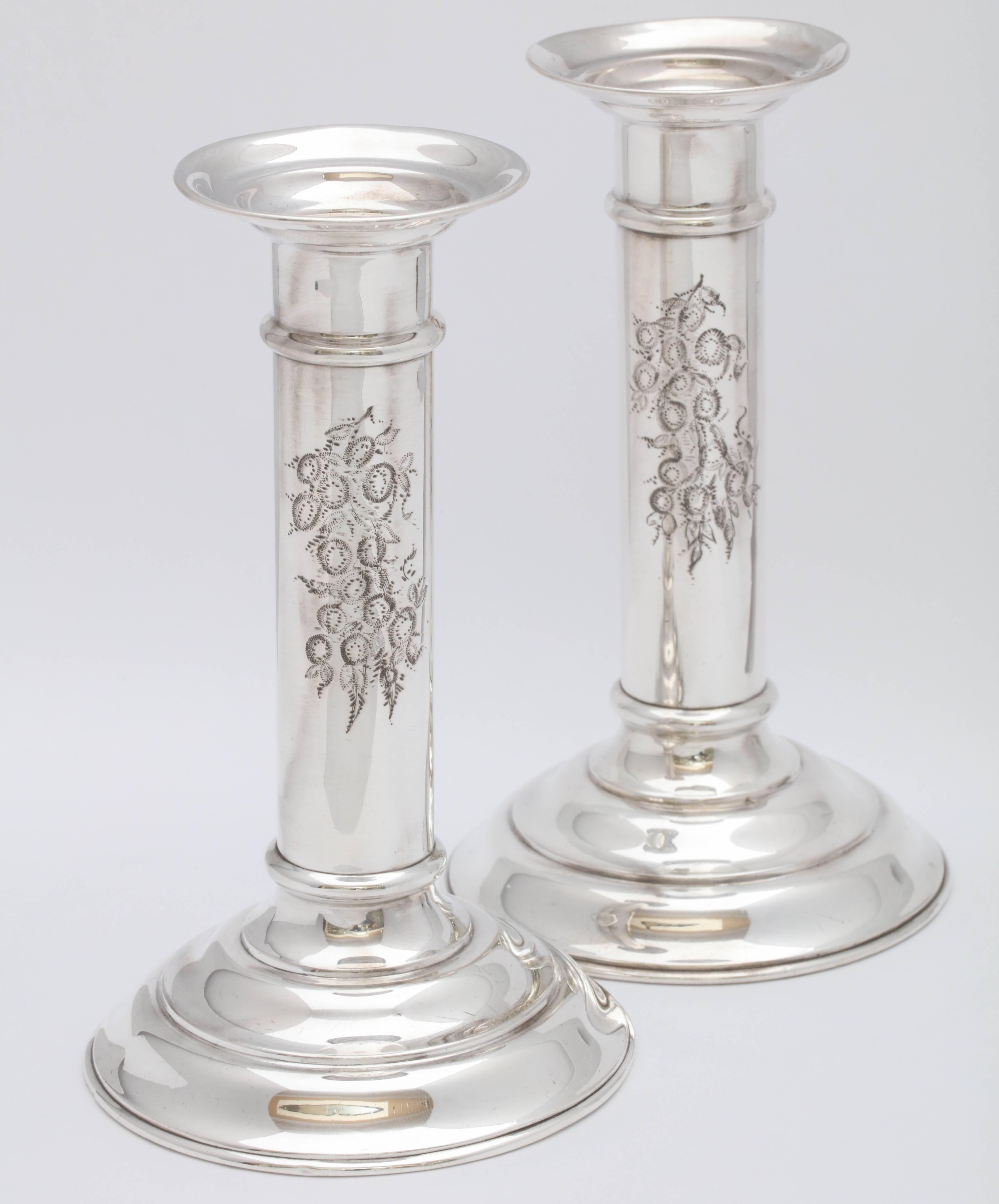 Pair of Edwardian, sterling silver, column-form candlesticks, R. Wallace and Sons Mfg. Co., Wallingford, Ct., circa 1910. Small, lovely floral design is etched into one side of each of the columns. Each measures 6 inches high x 3 1/2 inches diameter