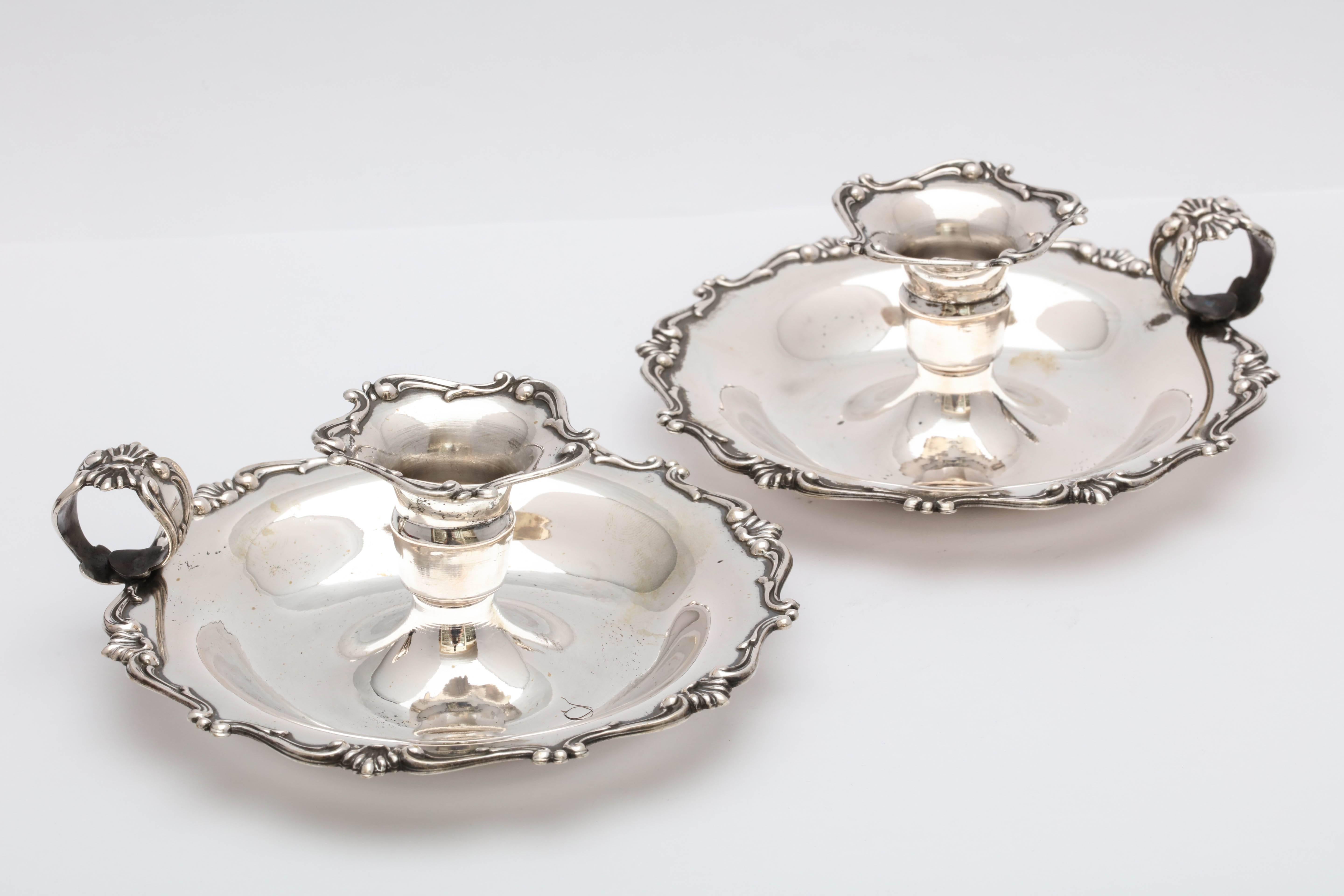 Pair of continental silver ‘.800’, Edwardian style chamber sticks, Italy, circa 1930s. Each measures five inches in diameter x 2 1/2 inches high. The pair weighs 5.875 troy ounces. Dark spots in photos are reflections. Excellent condition.