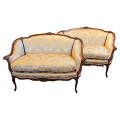 Pair of Edwardian walnut small salon sofas