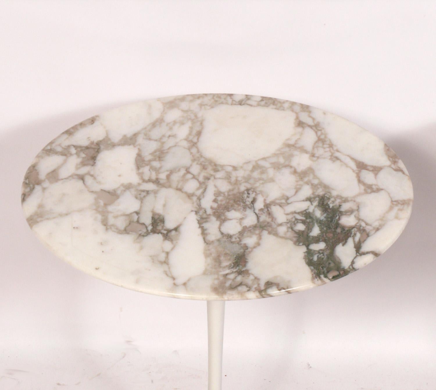 Pair of Marble Top Tulip Pedestal End or Side Tables, designed by Eero Saarinen for Knoll, American, circa 1970s. These are vintage authentic examples and are signed with a Knoll label underneath. They are a versatile size and can be used as side or