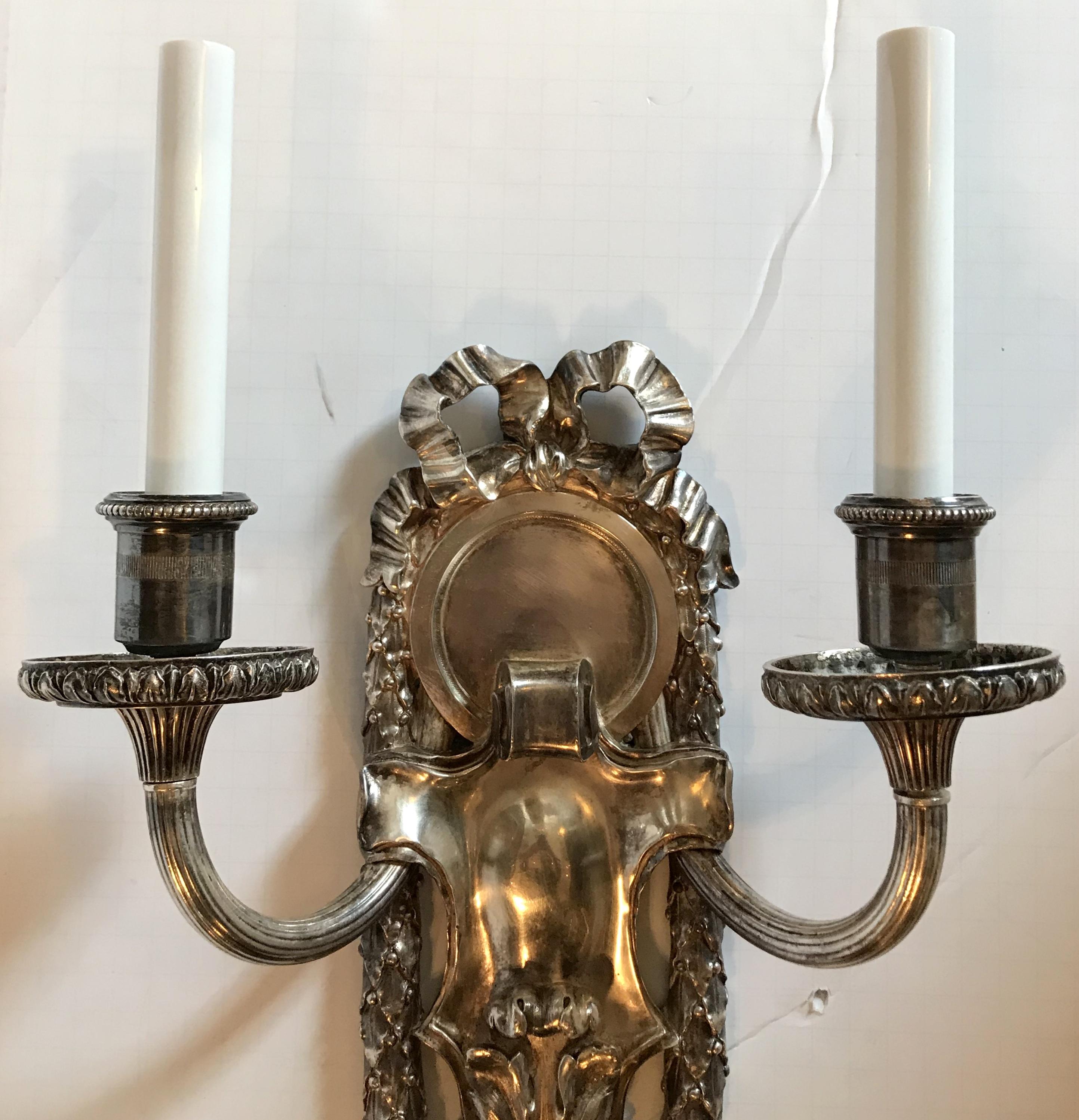 American Pair of E.F. Caldwell Polished Silver Two-Arm Neoclassical Bow-Top Sconces For Sale
