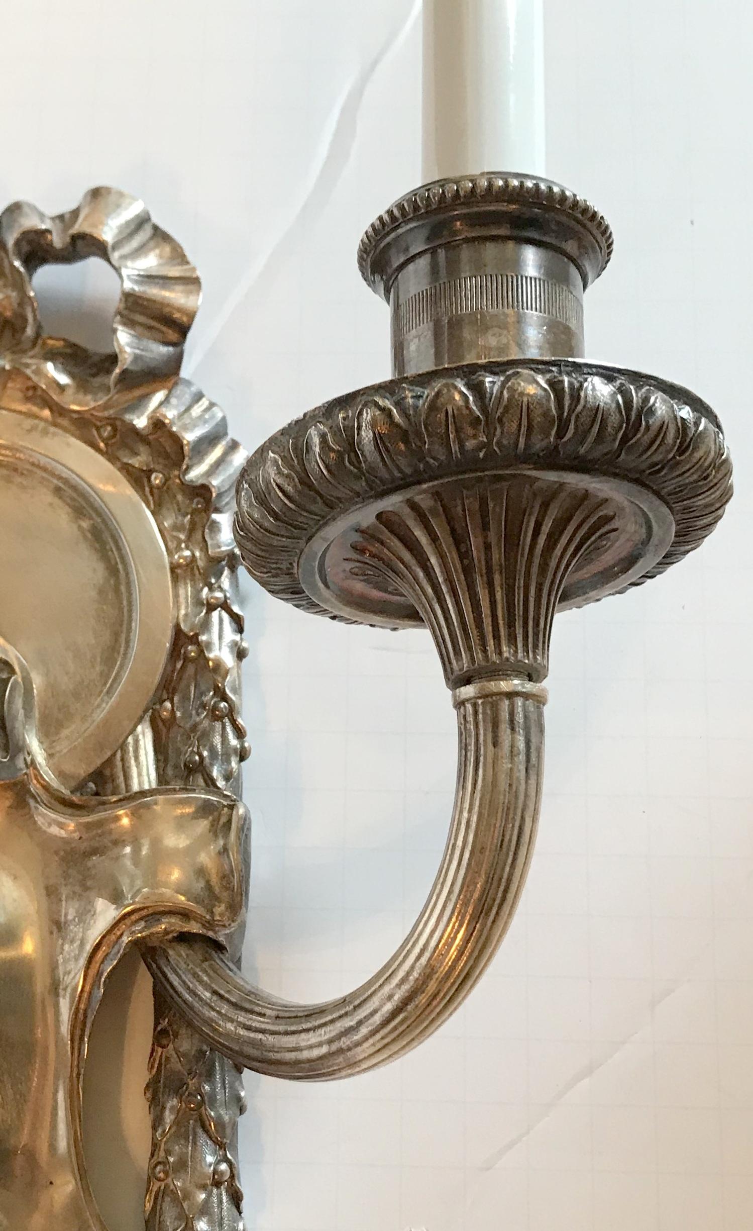 Pair of E.F. Caldwell Polished Silver Two-Arm Neoclassical Bow-Top Sconces In Good Condition For Sale In Roslyn, NY
