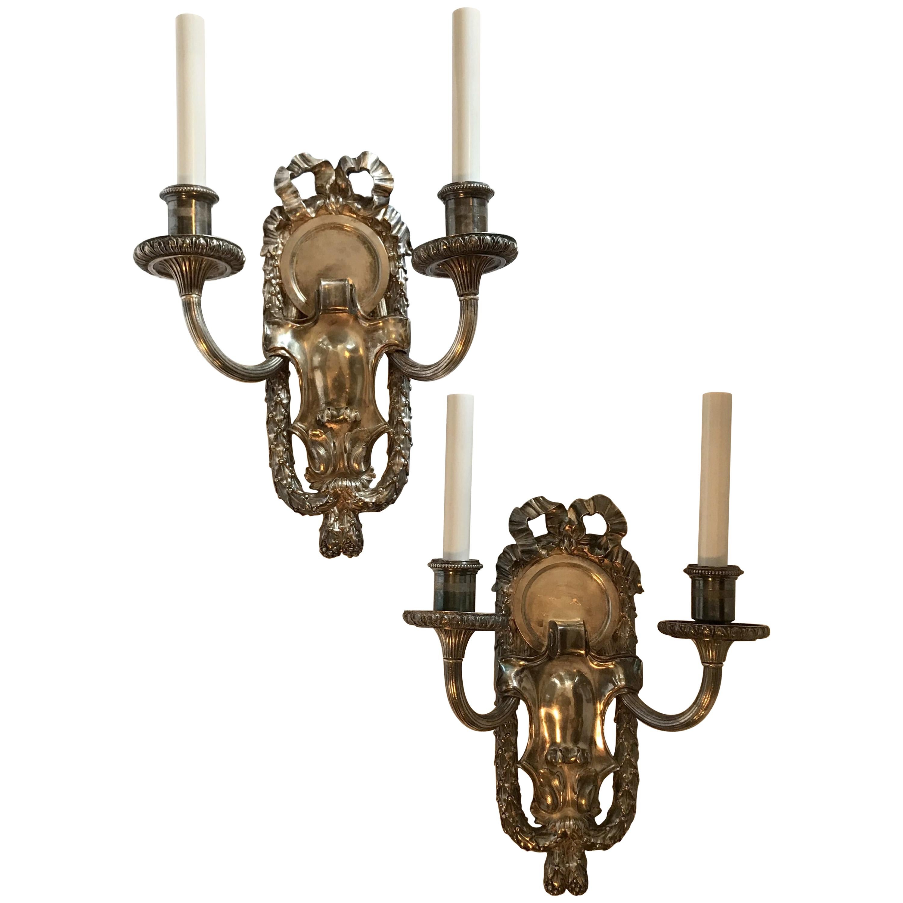Pair of E.F. Caldwell Polished Silver Two-Arm Neoclassical Bow-Top Sconces