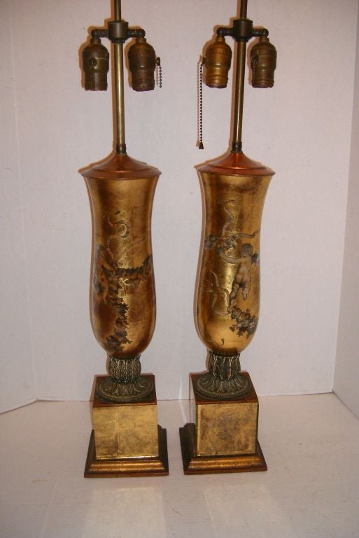Pair of French circa 1950's gilt and reversed painted table lamps with pedestal bases.

Measurements:
Height of body: 20