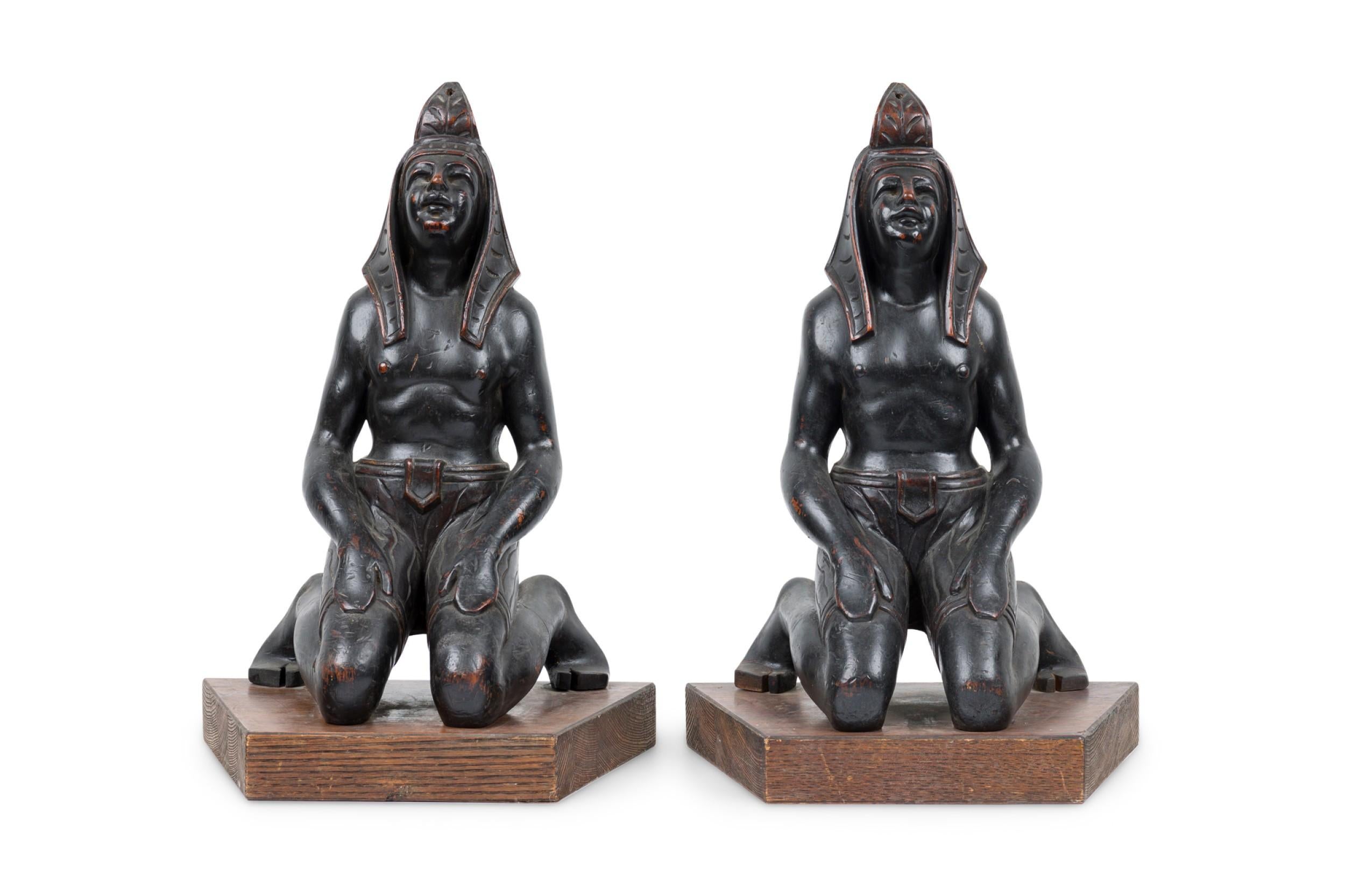 PAIR of Egyptian style (19/20th Cent) carved ebonized kneeling figures