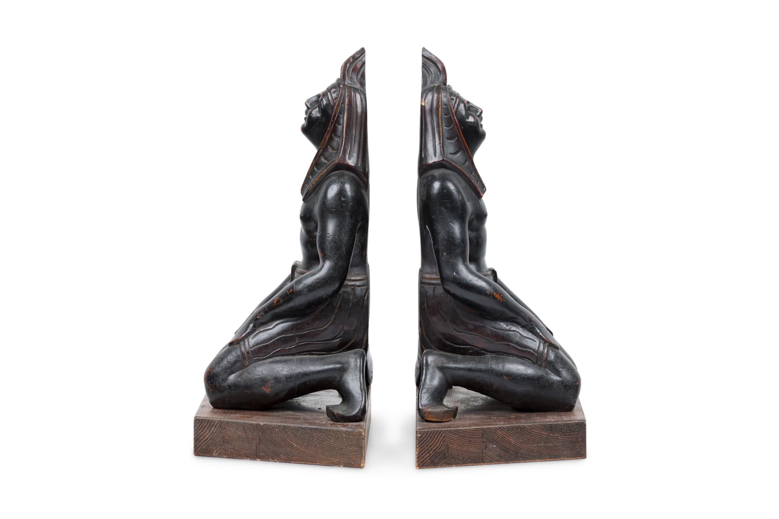 Egyptian Revival Pair of Egyptian Carved Ebonized Kneeling Figures For Sale