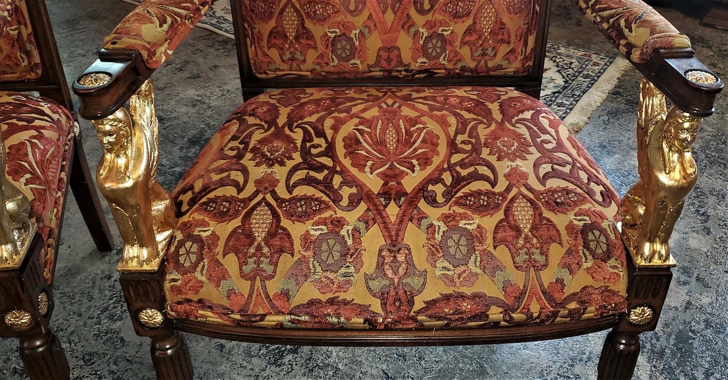 Presenting a gorgeous pair of Egyptian Revival armchairs with gilt Sphinx’s and highlights with original upholstery.

Mid-20th century and probably made by Maitland Smith, circa 1970/80.

Curved and scrolling back splats with upholstered fronts