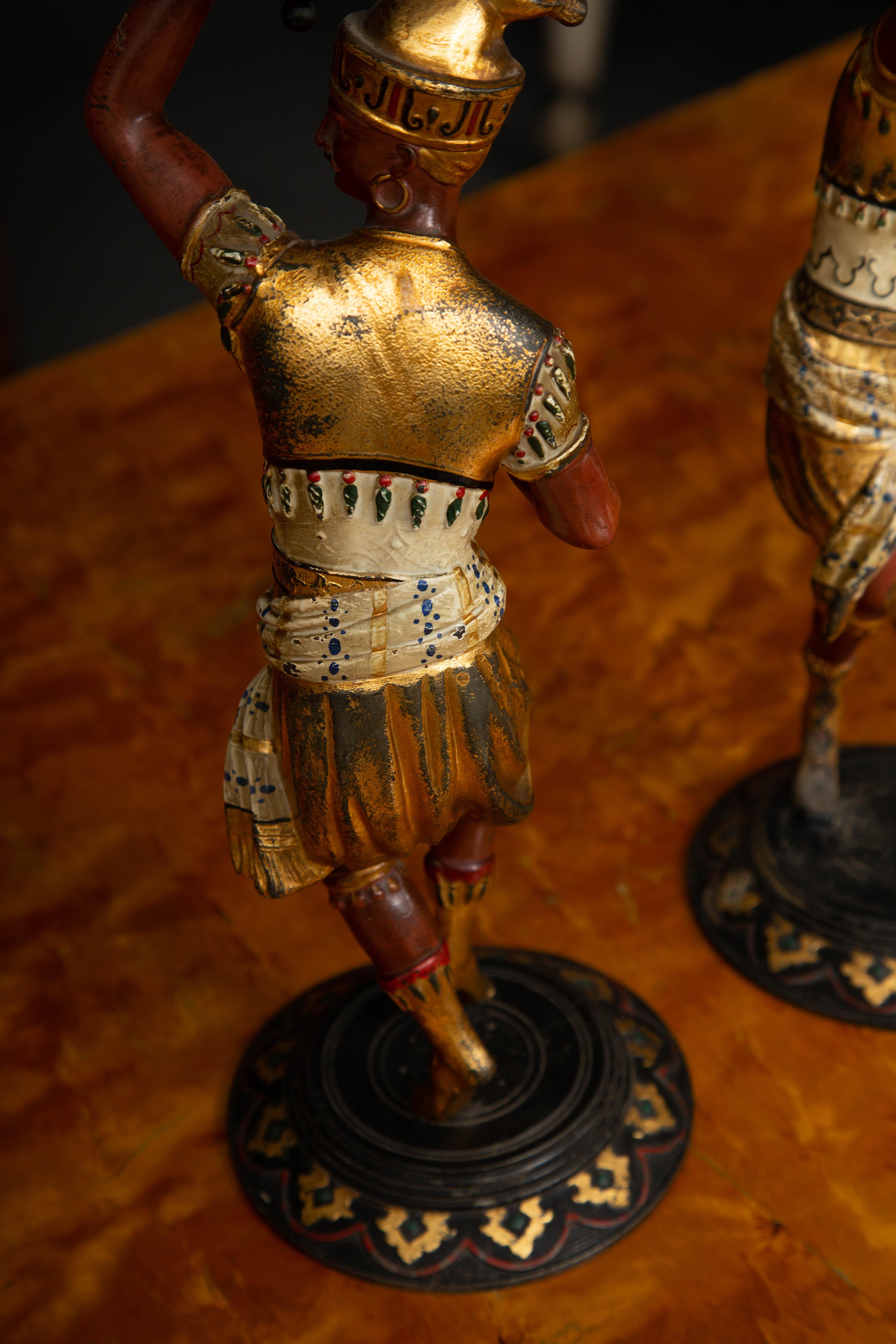 These are an interesting pair of Egyptian Revival Figures as candleholders. The figures are painted and offer an aged patina, mid-20th century.