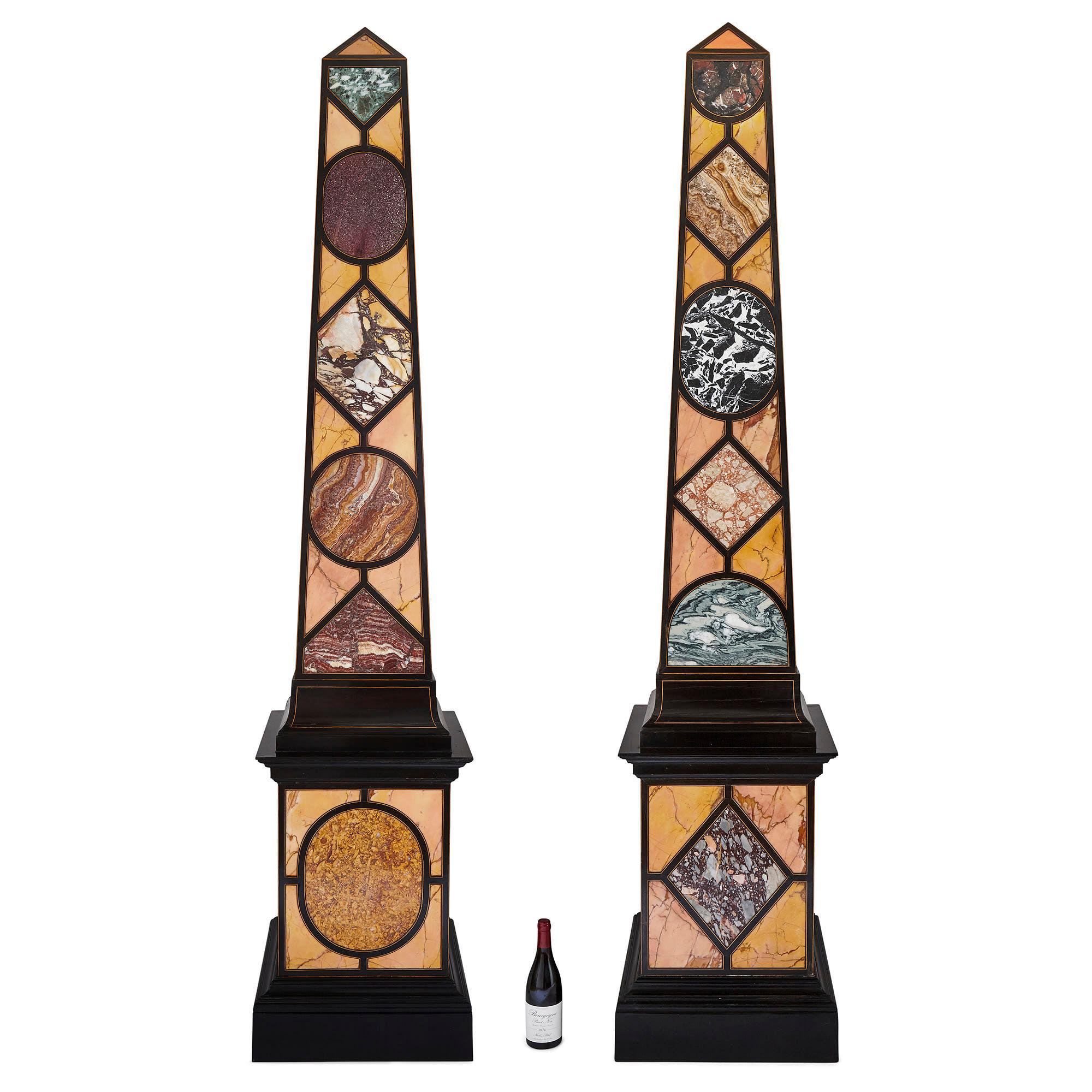 Pair of Egyptian Revival Italian specimen marble obelisks
Italian, 20th Century
Measures: Height 262cm, width 54cm, depth 54cm

The obelisks in this pair are superb demonstrations of native Italian marbles, with specimens including verde antico,