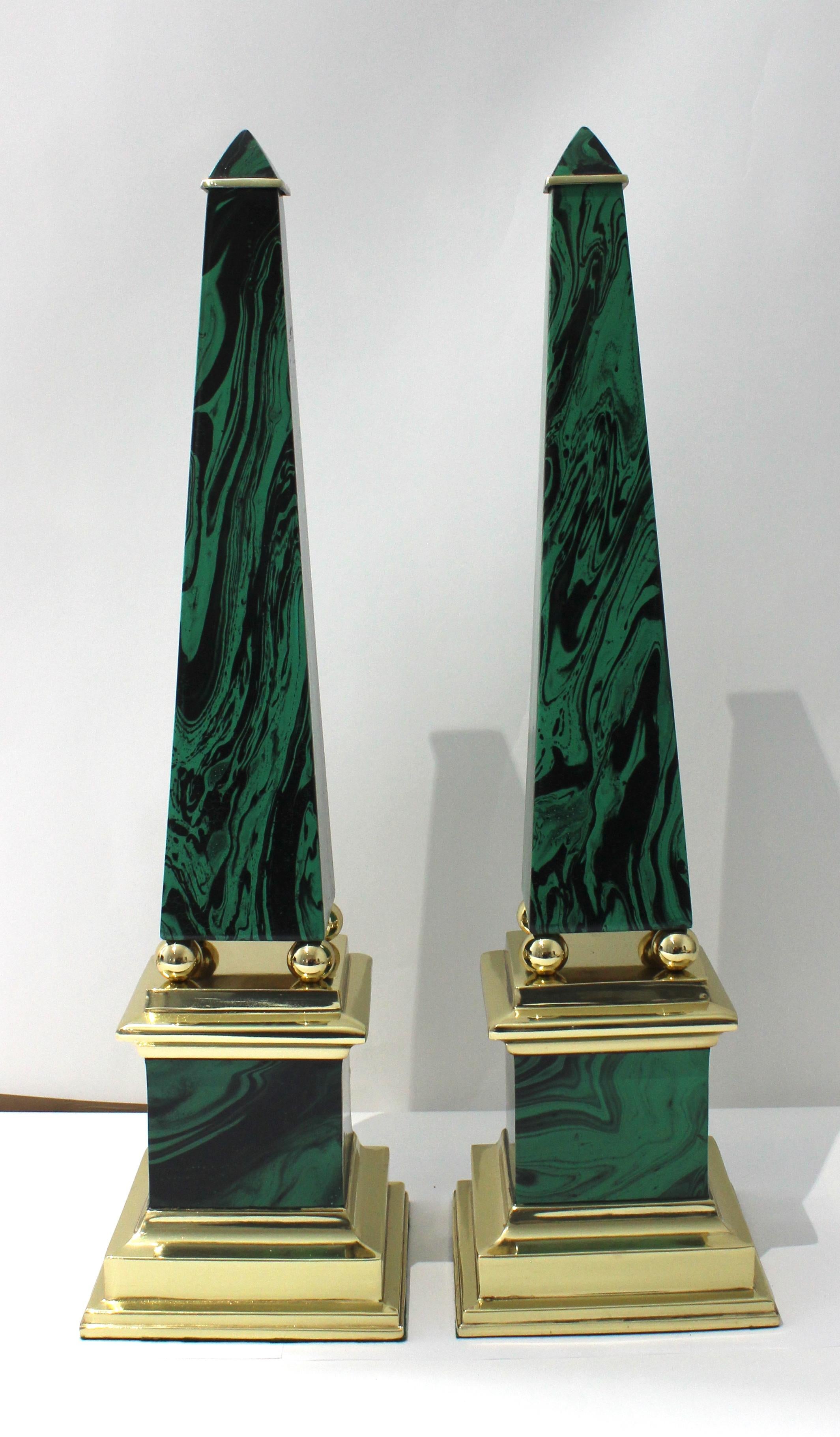This set of Chapman obelisks are very much in the Egyptian Revival style, and they are fabricated in brass plated steel, with a stylized, faux malachite finish.

Note: The pair of been professionally polished and finished with a clear lacquer, and
