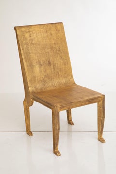 Pair of Egyptian-Revival style Parcel-Gilt Metal Sculptural Chairs