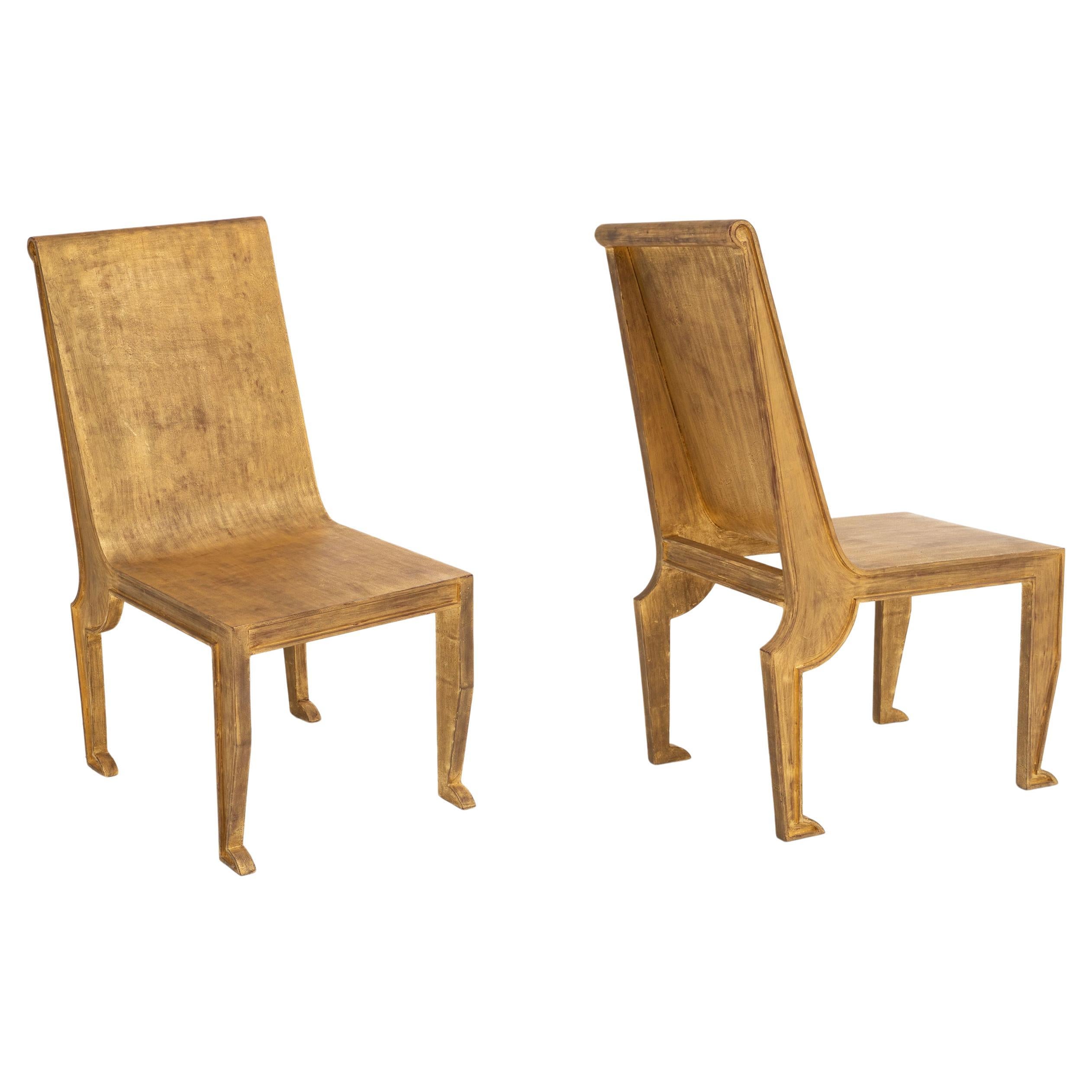 Pair of Egyptian-Revival style Parcel-Gilt Metal Sculptural Chairs