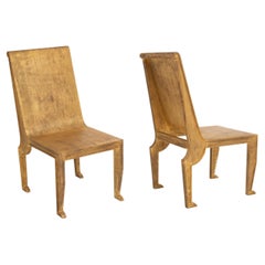 Pair of Egyptian-Revival style Parcel-Gilt Metal Sculptural Chairs