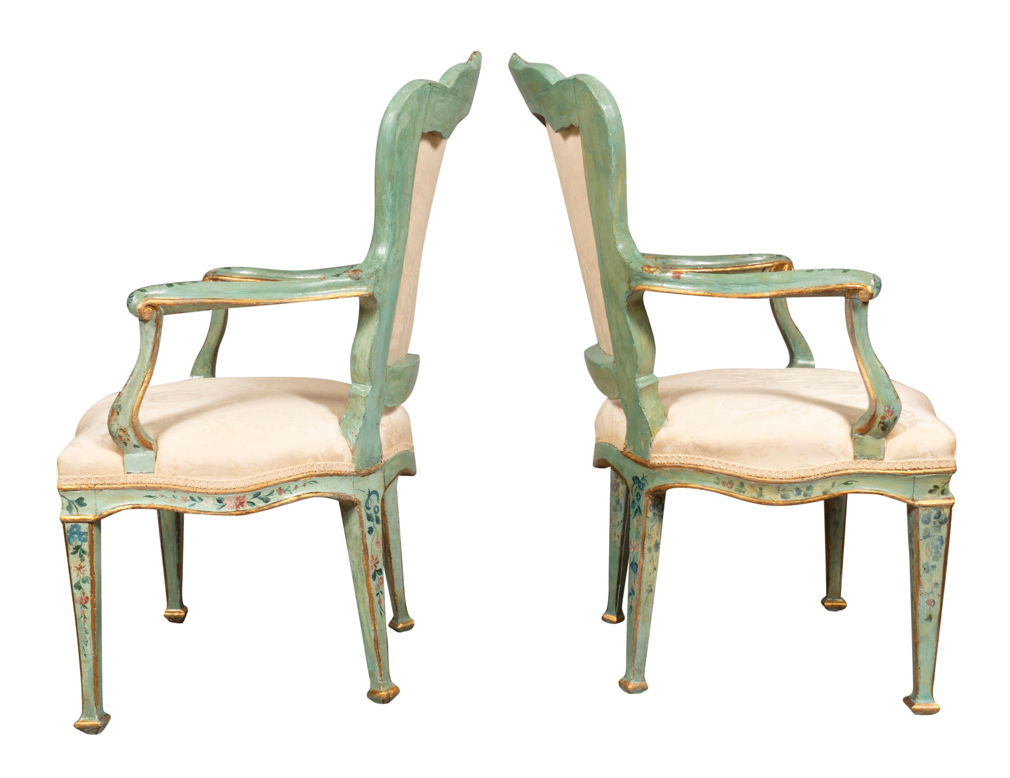 Transitional with a shaped arched upholstered back and seat raised on square tapered legs. Wonderful original painted surface with a light green and painted with floral sprays and gilded details. Sturdy and usable.