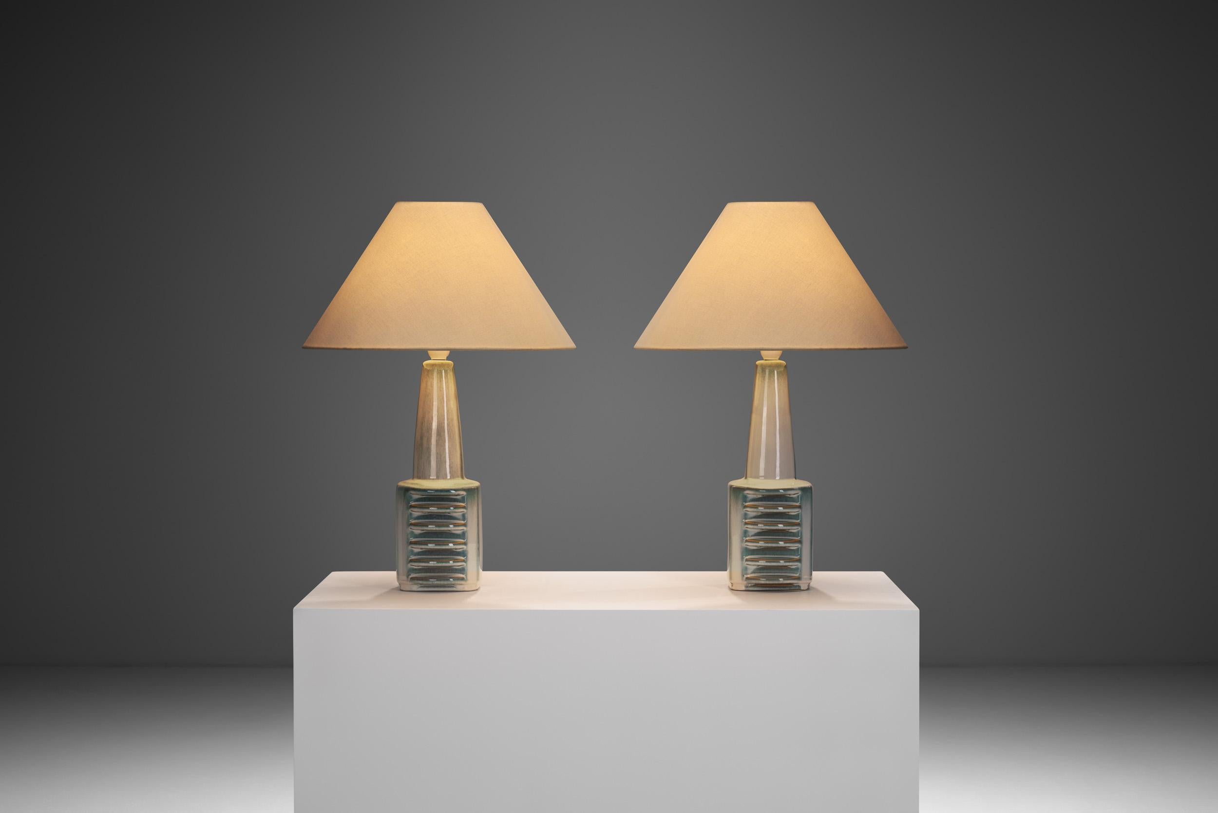 This pair of stoneware table lamps was designed by the brilliant Danish artist,  Einar Johansen, and produced by Søholm Stentøj (Søholm Stoneware). The manufacturer was one of the oldest and most revered names in Danish ceramics. It was founded in