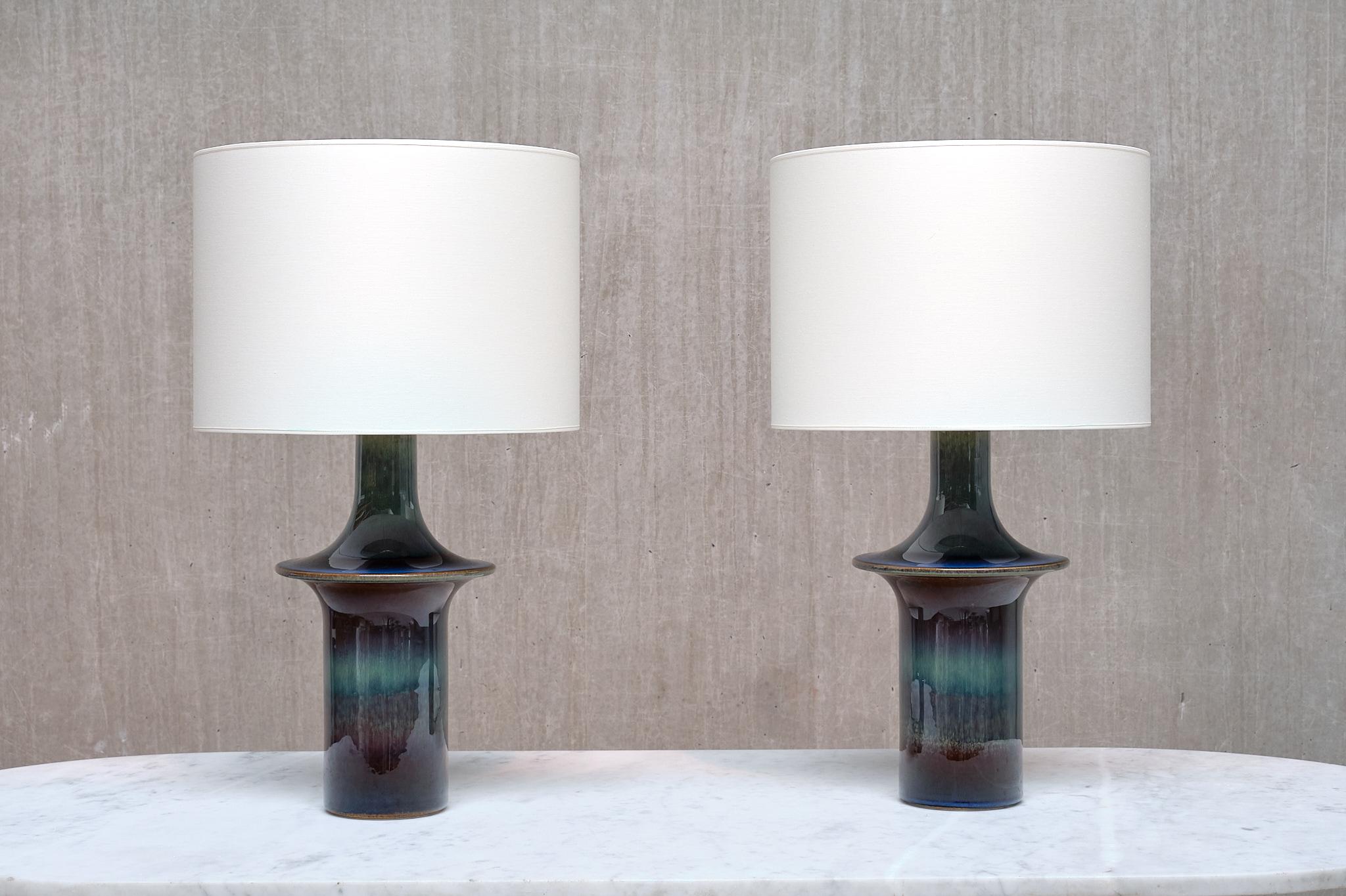 This striking pair of generously sized table lamps was designed by Einar Johansen and produced by Søholm Stentøj in Denmark during the 1960s. Each lamp is stamped with the manufacturer’s name and the model number 1070 on the underside of the