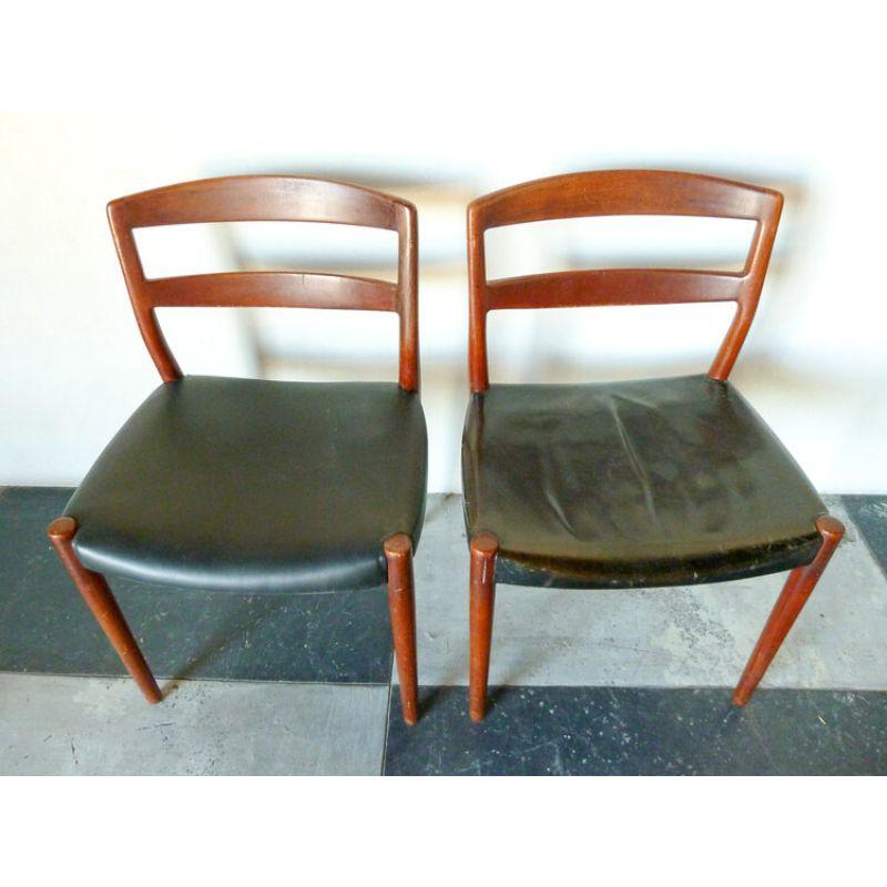 Pair of Ejner Larsen and Aksel Bender Madsen dining chairs made with teak frame and black leather upholstery. Designed in 1956 and manufactured by Willy Beck. Upholstery repair made to one chair with new leather. Original leather and metal makers