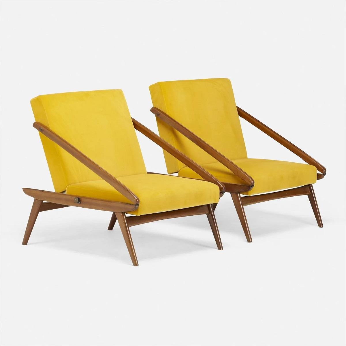 Pair of Ejvind A. Johansson adjustable lounge chairs for ISA Bergamo. The chairs have mahogany frames, velvet upholstery and can adjust to a flat or upright position. There is a metal manufacturer's label to the underside of one of the chairs 