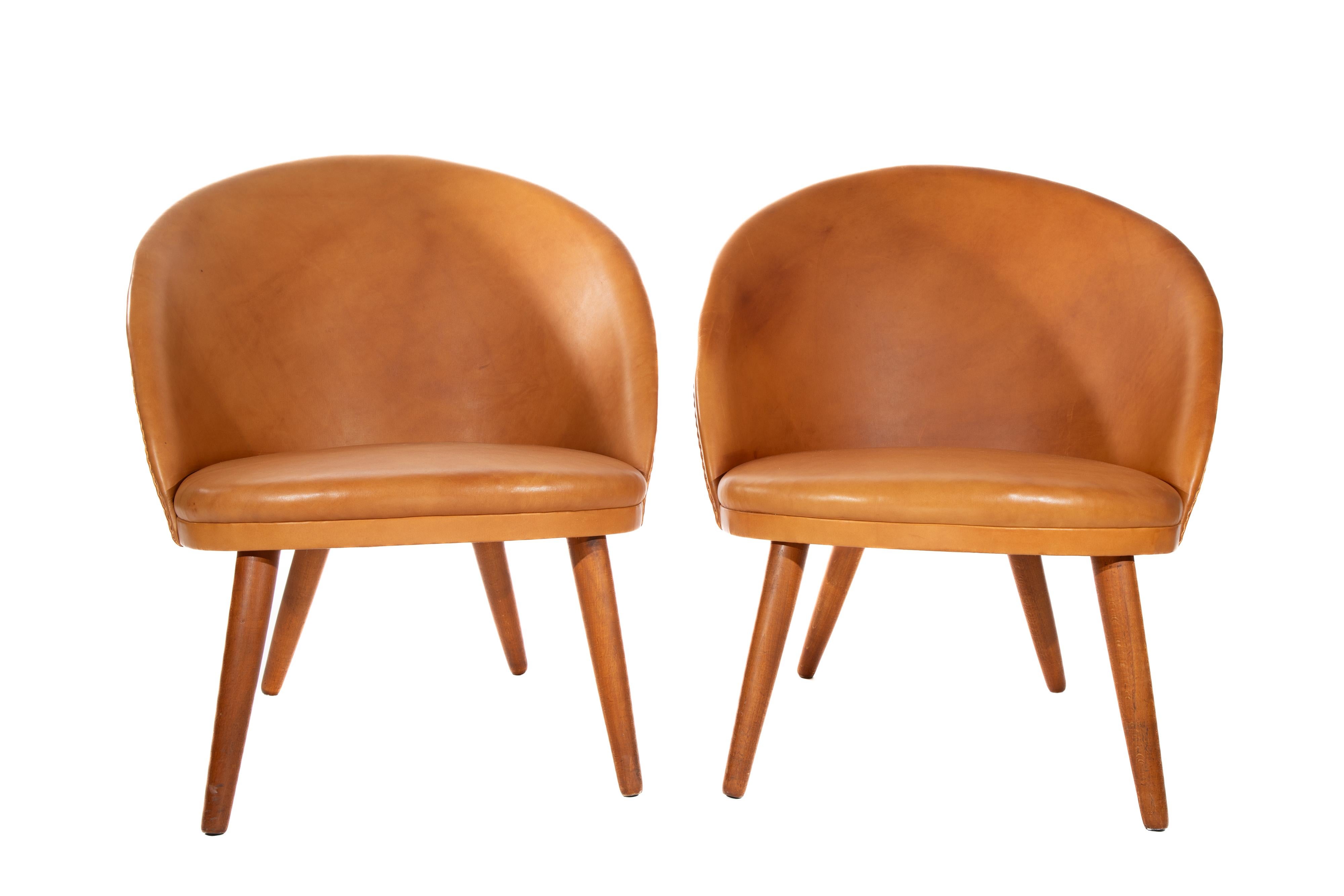 Pair of Ejvind Johannson leather and teak lounge chairs.   Model 301 
Manufactured by Godtfred H. Petersen, Denmark
C.  1950s

Newer upholstery with light wear