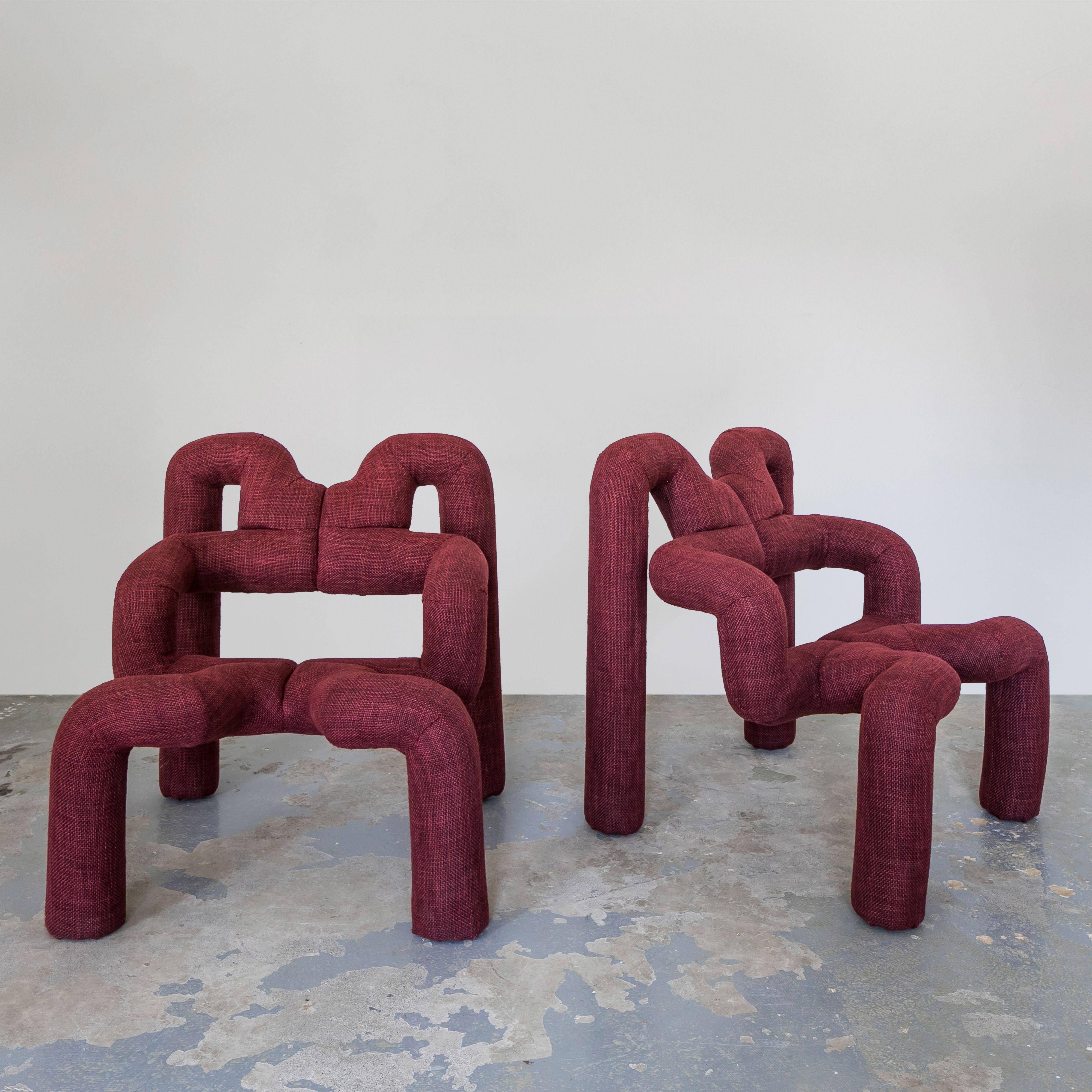 Extrem Chairs by Terje Ekstrom upholstered in a burgundy wool by Loro Piana. Both sculptural and comfortable these Norwegian chairs are designed with ergonomics to provide back support and multiple ways to sit. Ekstrom was one of the first