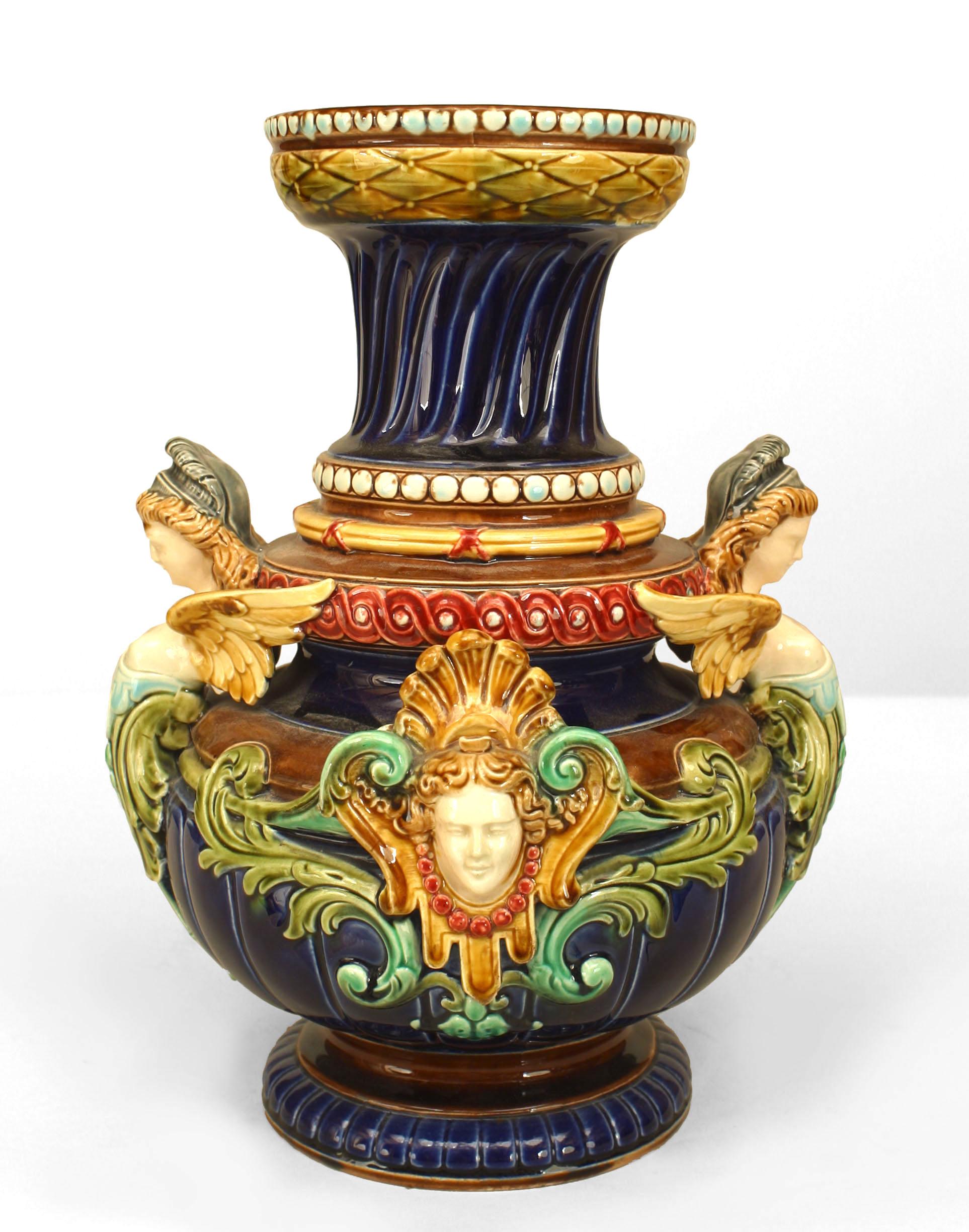 Pair of nineteenth century Majolica vases featuring a multi-tiered, baluster base composition as well as a bold and eclectic usage of color and design. Notably, the vases are impressed 