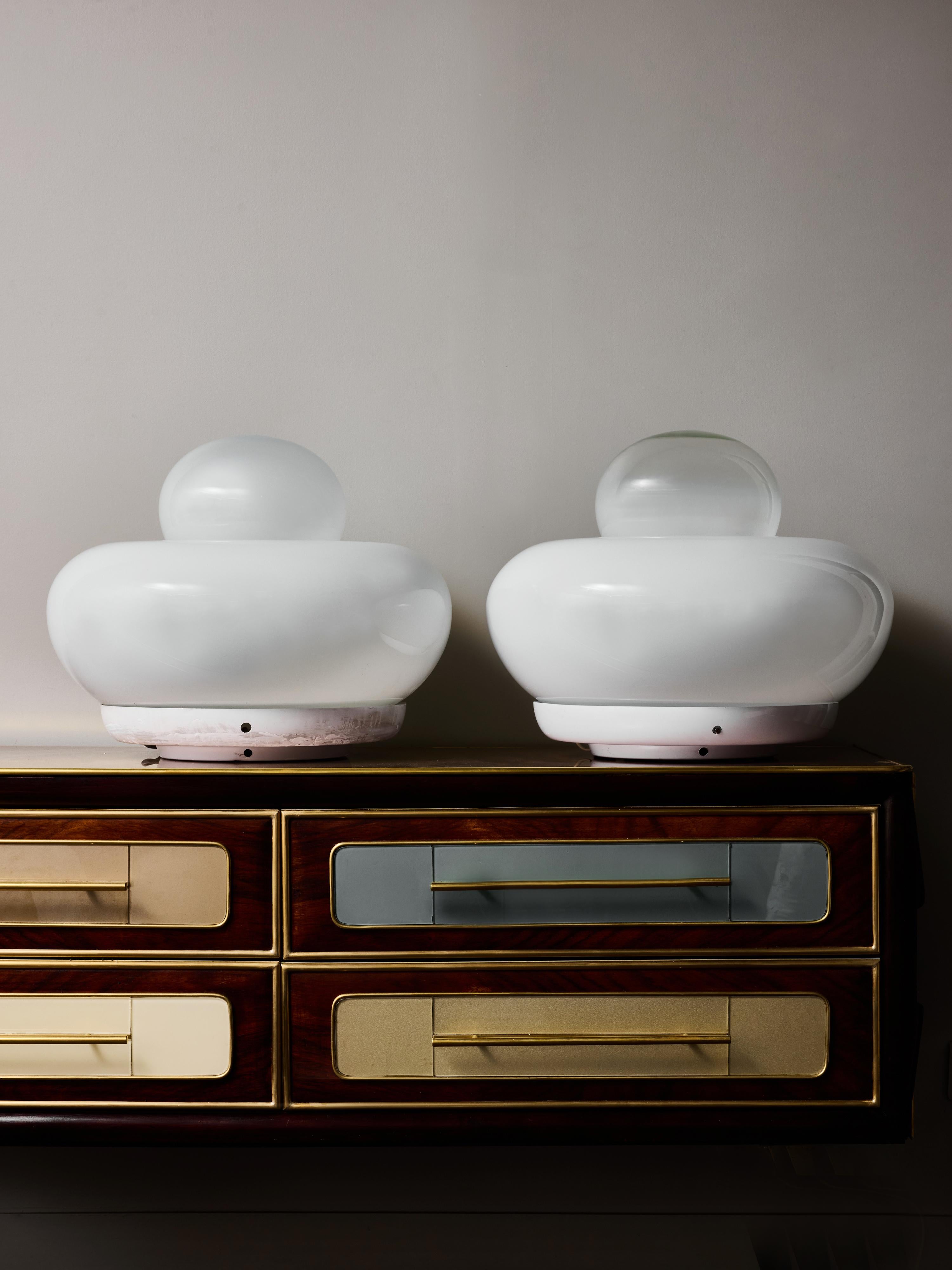 Iconic pair of “Electra” table lamps designed in 1968 by noted Italian architect and designer Giuliana Gramigna for Artemide. These sculptural lamps capture the essence of late-1960s Italian design.

Each lamp is composed of two interlocking