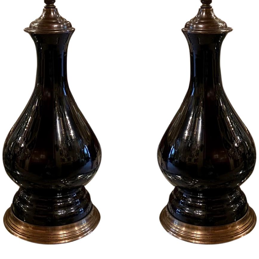 A pair of French circa 1920's black opaline glass electrified oil lamps with metal bases.

Measurements:
Height of body: 13