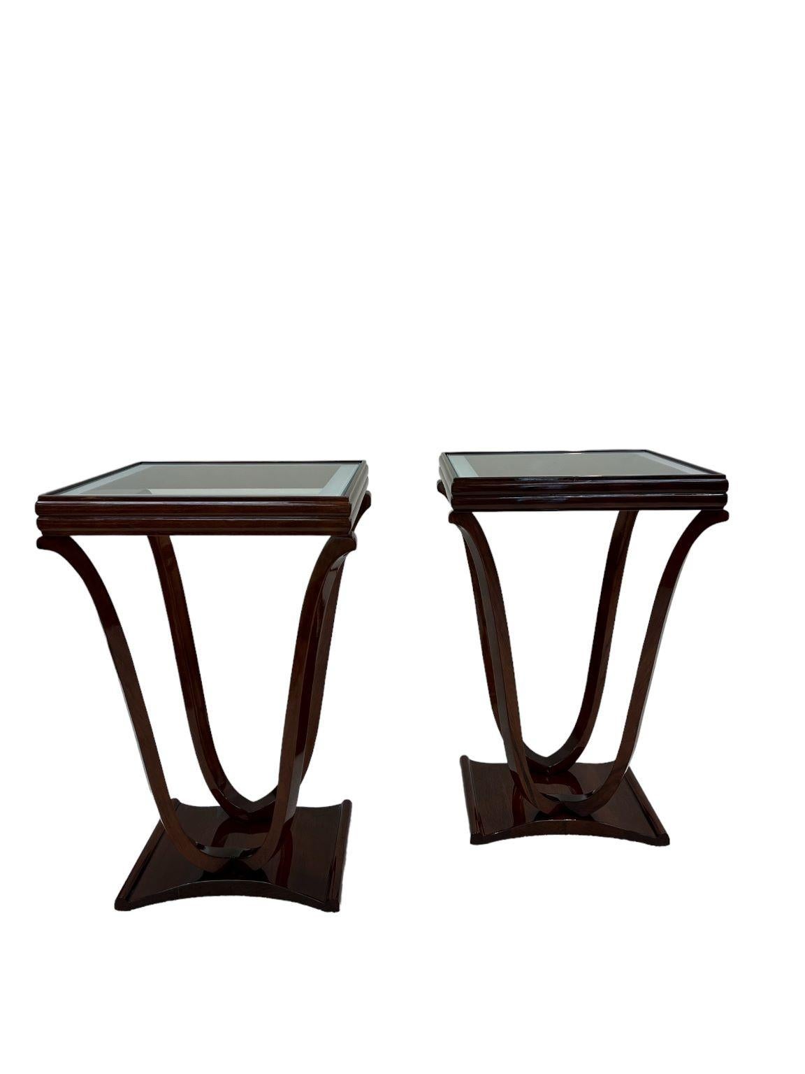Pair of American Art Deco tulip shaped glass top end tables. A new glass top with a frosted edge highlights the elegant curving legs of this beautiful American Art Deco table from the 1930's. The solid maple wood table is expertly restored in a