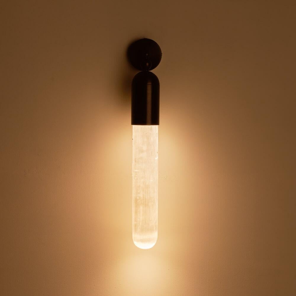 The Selene range is the result of our project of combining light with a particular apotropaic stone - Selenite: a mineral chalk whose surface presents defined and irregular striations along the length of the crystal. The light that passes through