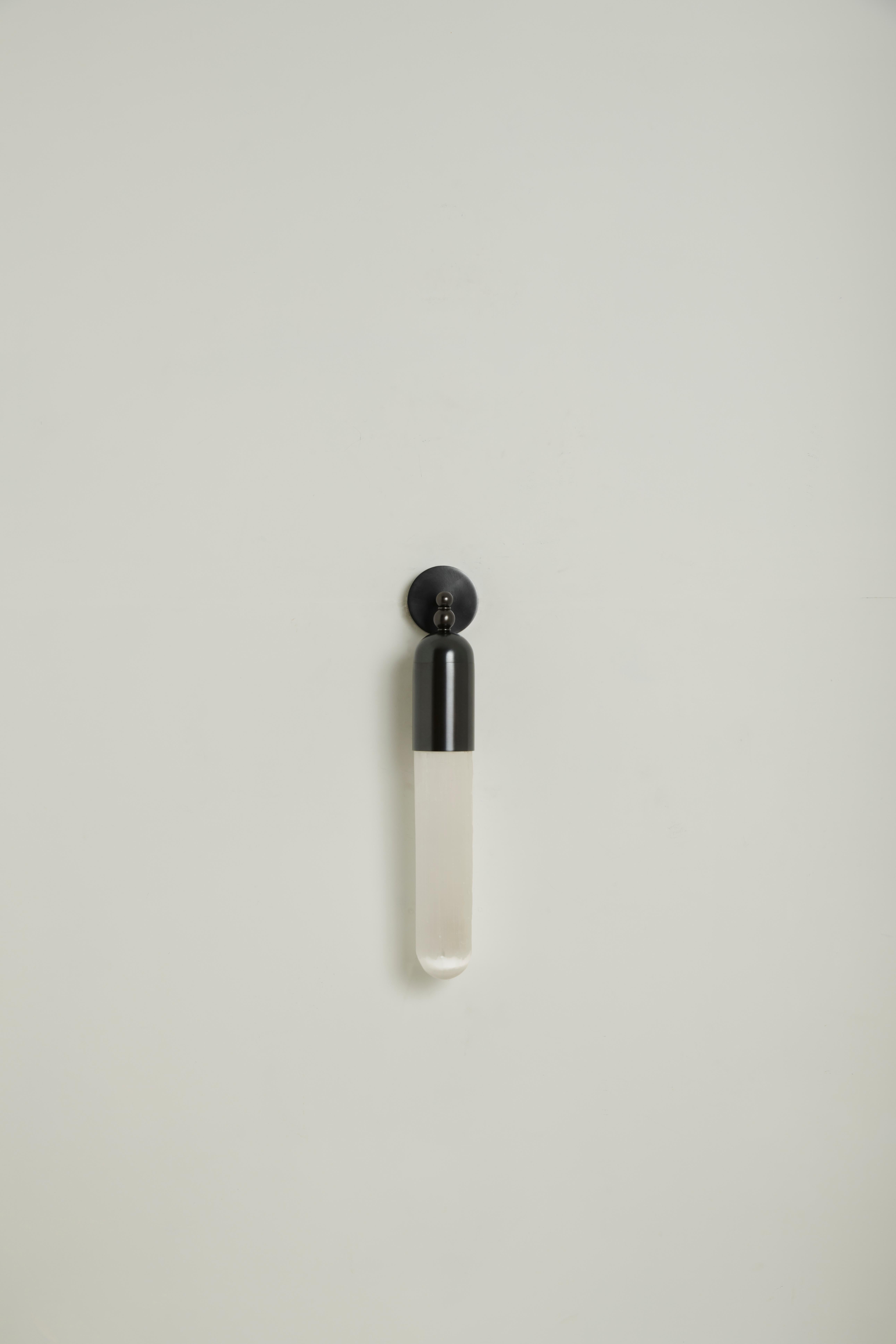 The Selene range is the result of our project of combining light with a particular apotropaic stone - Selenite: a mineral chalk whose surface presents defined and irregular striations along the length of the crystal. The light that passes through