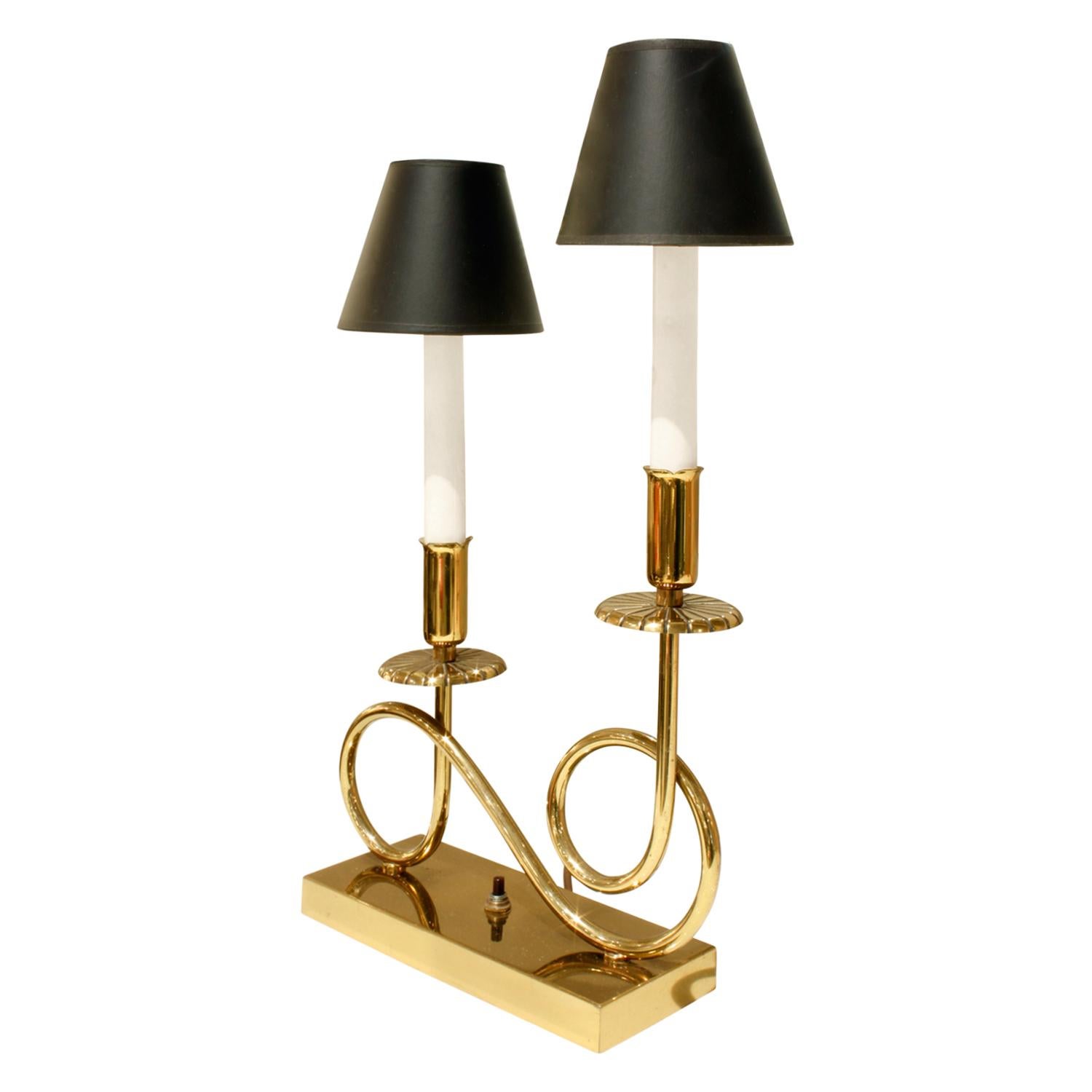 Pair of elegant brass table lamps, each with 2 lights, in the style of Tommi Parzinger, American 1950's  Shades are black paper.

W: 10 inches / 11 inches with shades
D: 3.5 inches / 4 inches with shades
H: 18.5 inches