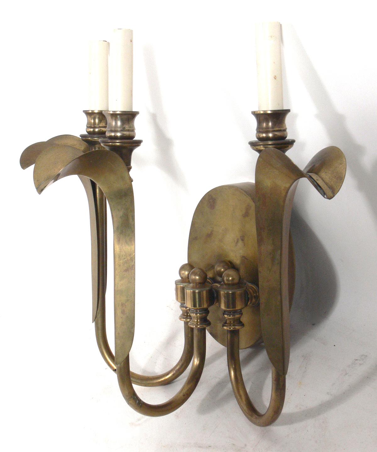 Pair of elegant brass sconces, in the manner of Tommi Parzinger, American, circa 1960s. They retain their warm original patina. They have been rewired and are ready to use.