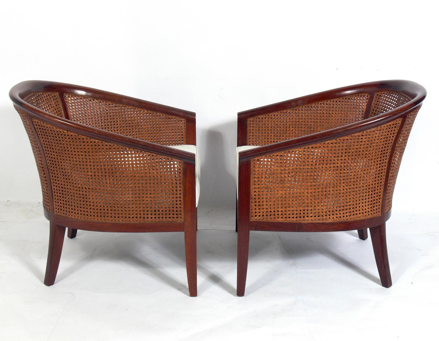 Pair of elegant caned back lounge chairs, circa 1960s. They have been reupholstered in an ivory color herringbone upholstery.