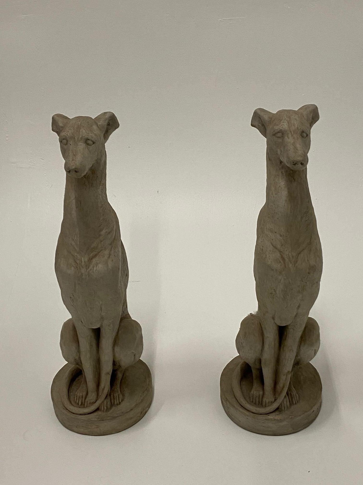 A striking pair of cast cement whippet dog sculptures with beautiful detail originating from a Pennsylvania estate.