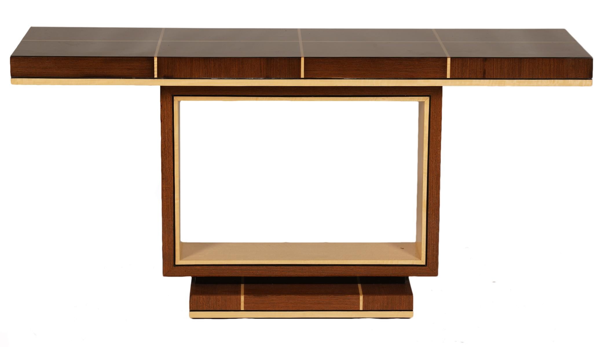 The console table features  a long top divided into rectangles by light cored stripes of inlay resting on an upright rectangular two color frame sitting on a square base that repeats the top's pattern.