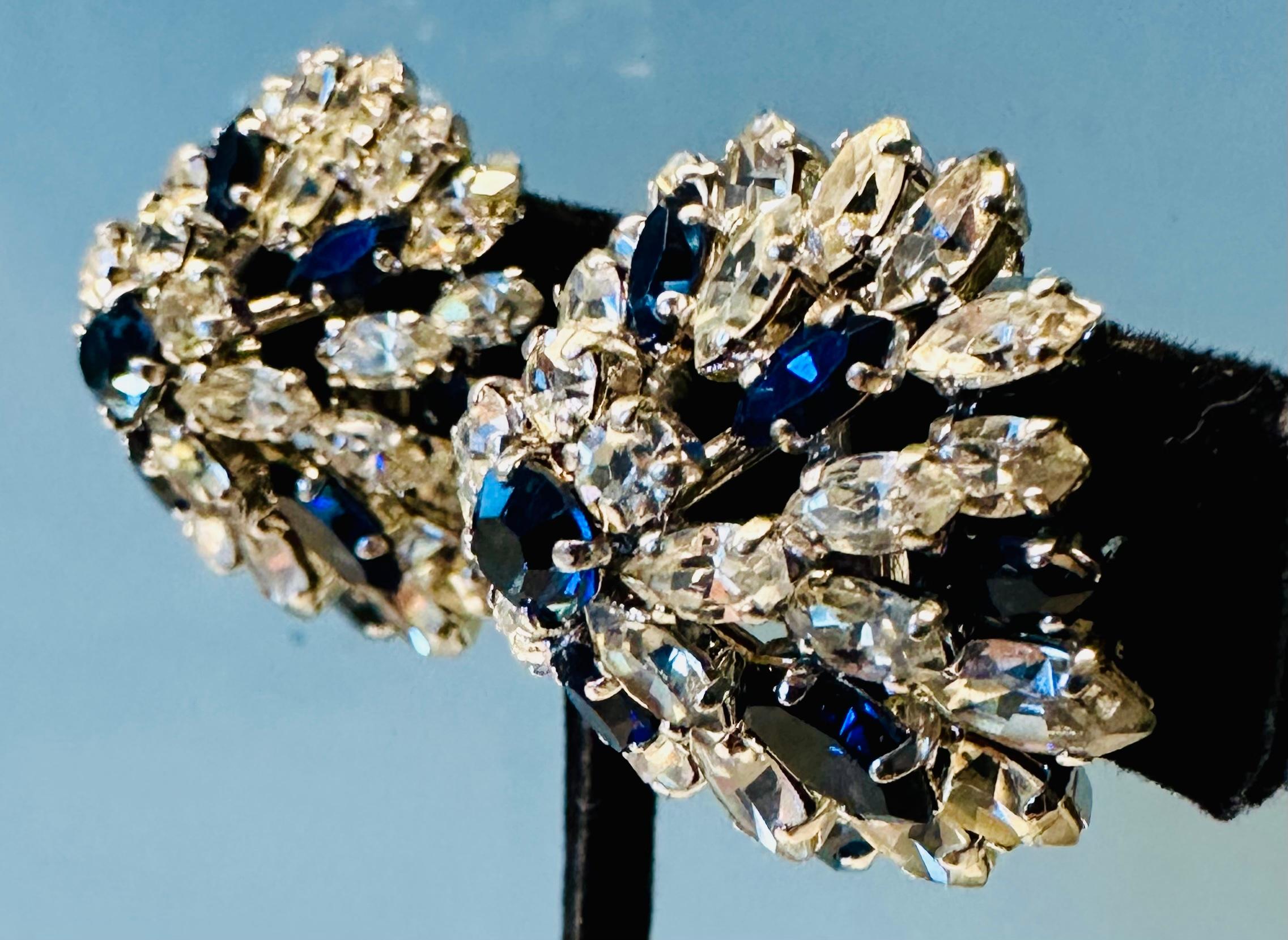 An absolutely stunning early example of a pair of 1960s Christian Dior earrings with blue and clear crystals.  The earrings are a classic example of Dior's elegant and sophisticated design and are made with a series of blue and clear crystals that