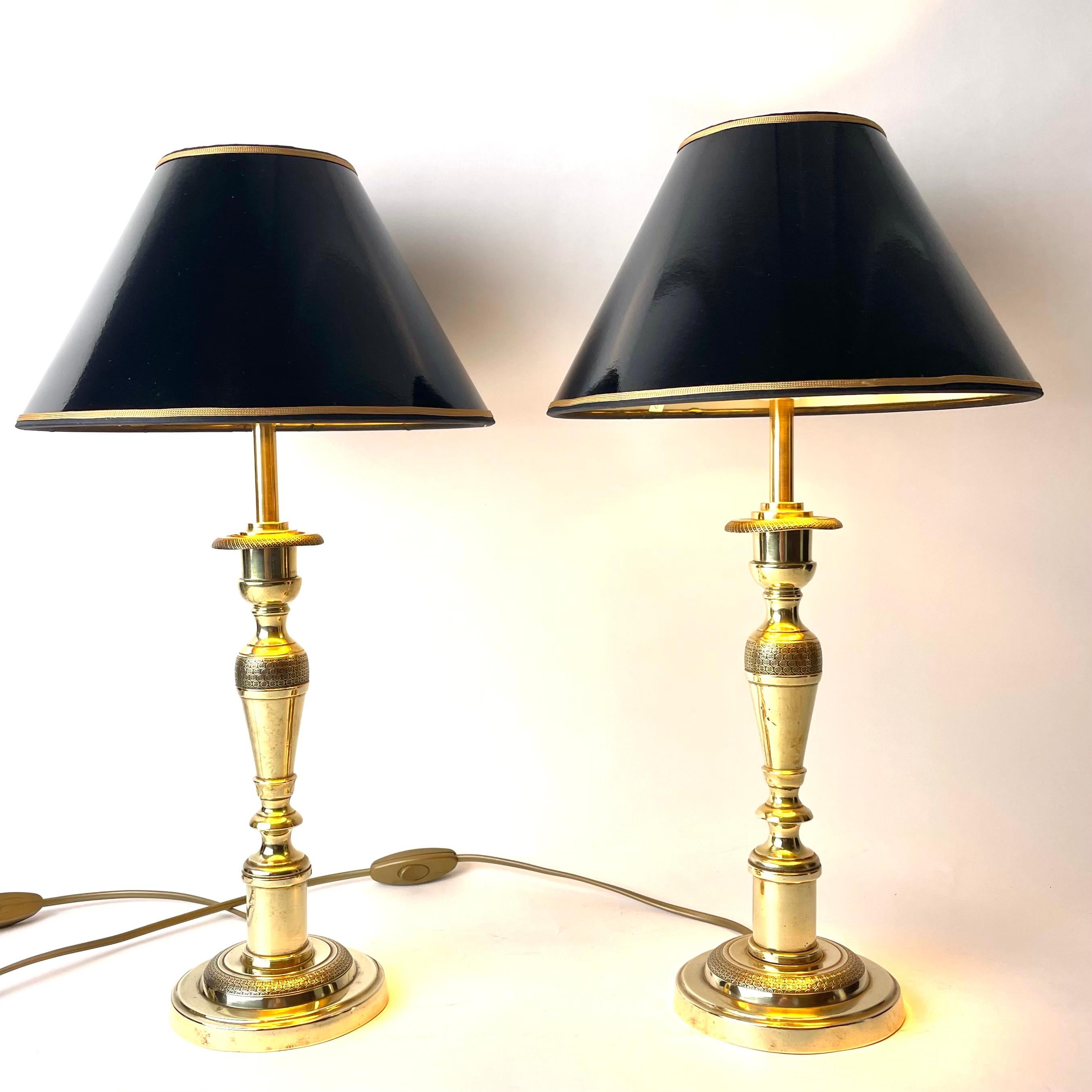 Pair of Elegant Empire Table Lamps in Brass. Early 19th Century France, originally candlesticks. 

This pair of exquisite table lamps combine excellent neoclassical forms of column bases and urns with Empire sensibilities in ornamentation. Areas of