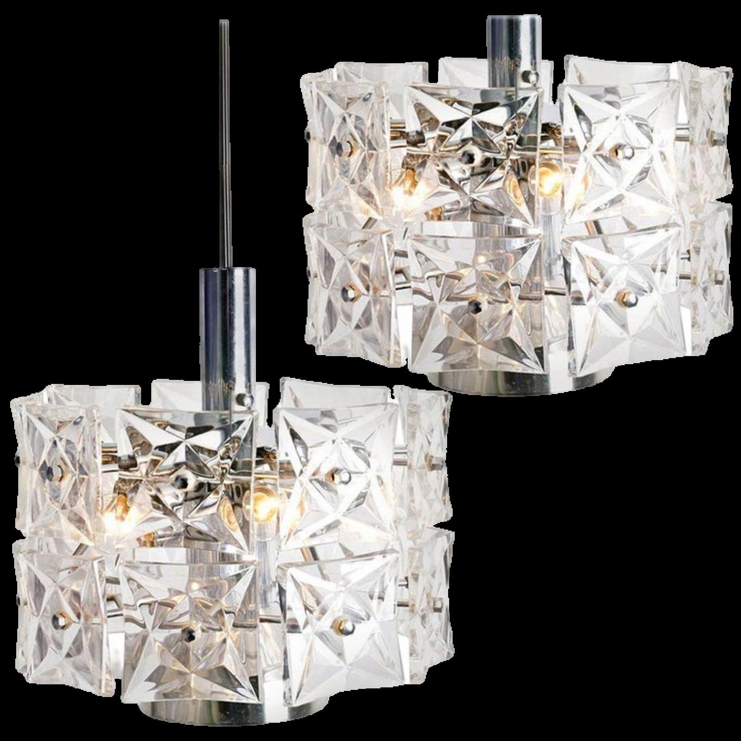 A pair of very modern, elegant and fine Kinkeldey chandeliers. Really heavy quality. They are comfortable with all decor periods. This chandeliers are executed to a very high standard. The quality large square crystals beautifully reflecting the