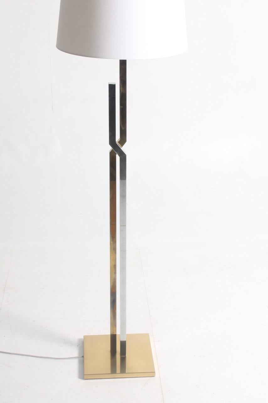 Pair of elegant floor lamps in brass and chromed steel combined. 
Designed and made by Holm Sørensen. This lamp is a Fine example of minimalistic Scandinavian design and quality. Made in Denmark, circa 1960.