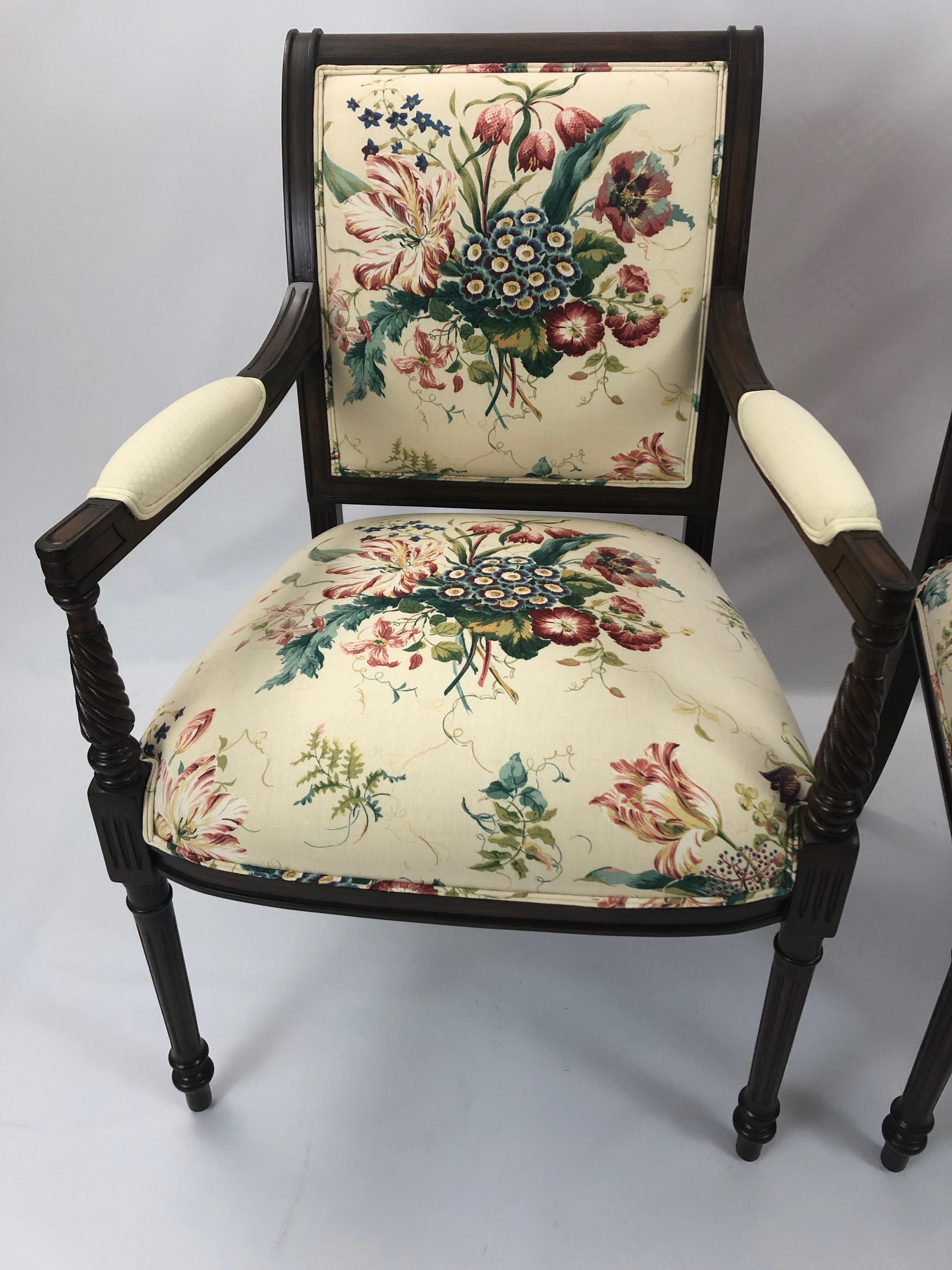 Two lovely fruitwood armchairs having elegant turned legs and pretty floral upholstery on the front and arms. The back is a coordinated raspberry solid upholstery.
Measures: Arm height 28.25
seat depth 19.