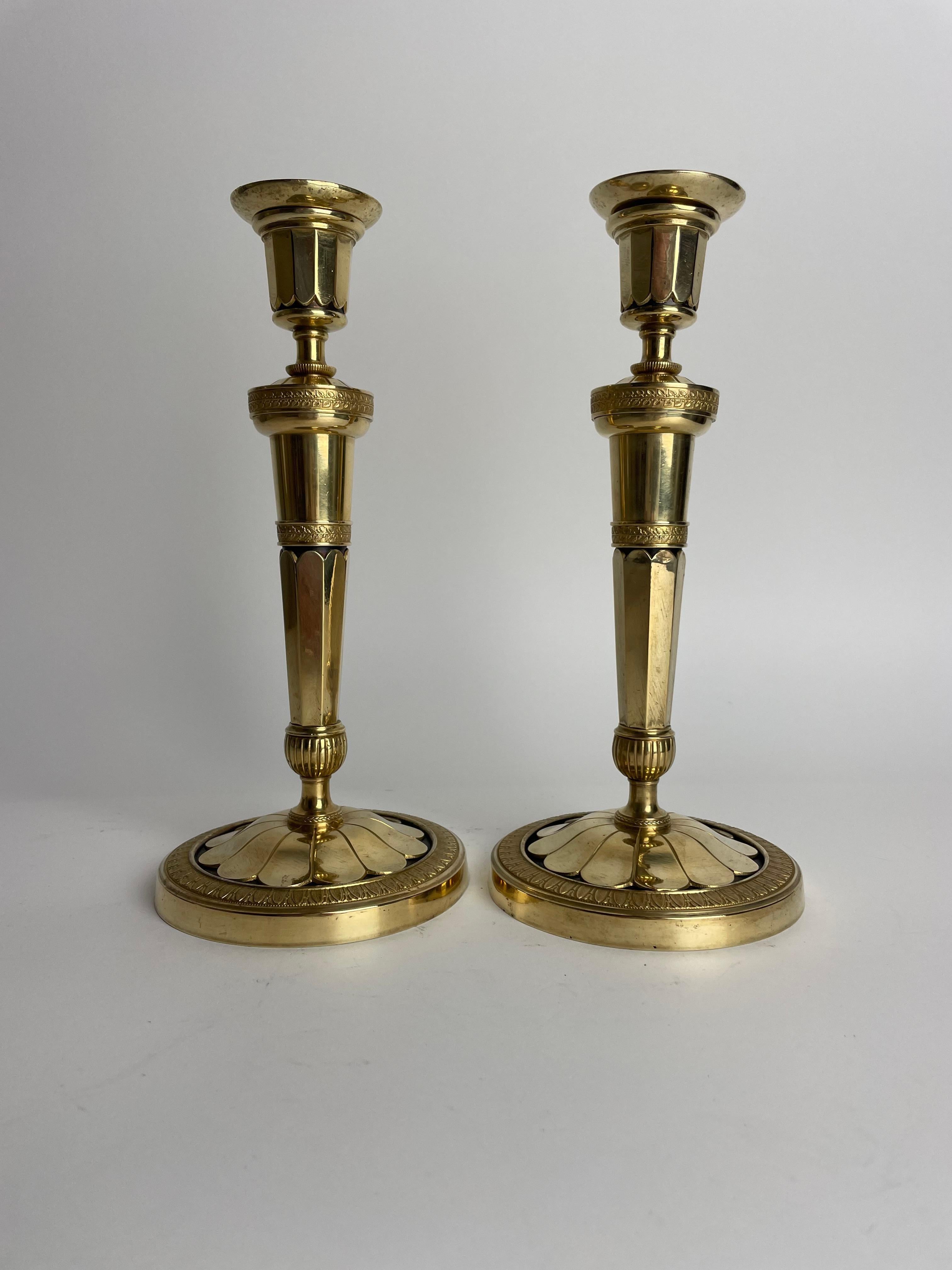 A pair of extremely elegant gilded and dark patinated bronze Empire Candlesticks. Probably made i Paris around 1810. Beautiful contrast between the gilded and dark patinated bronze.

Wear consistent with age and use.