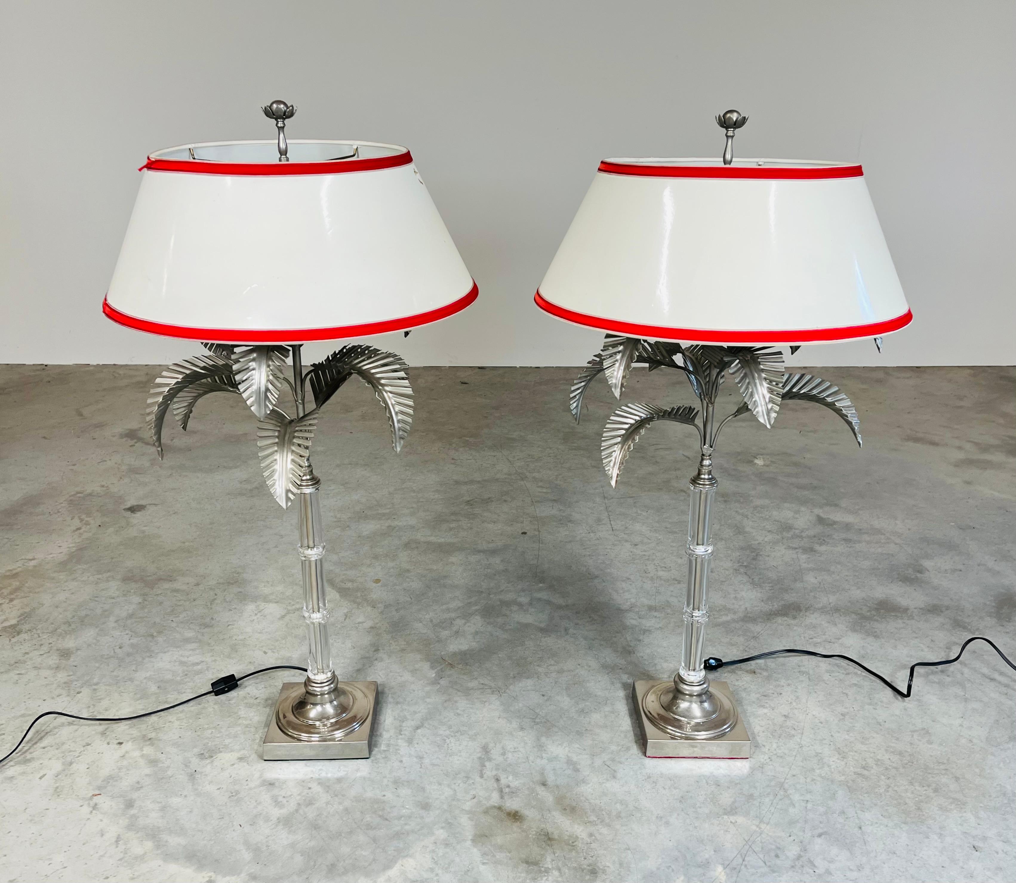 Pair of elegant faux bamboo glass stem lamps having brushed nickel palm leaves and bases with original matching detailed finials by Chapman circa 1970. 
In very nice vintage condition with new wiring having 1970’s style plugs to complete the look.