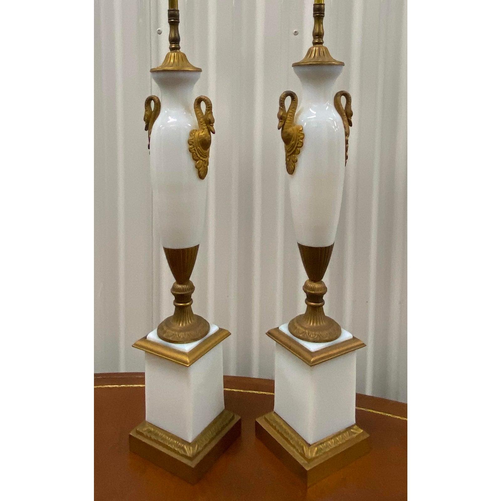 Pair of elegant opaline glass table lamps with gilded brass ormolu mounts, circa 1940

These are absolutely gorgeous!

The lamps sit atop a square column base capped with gilded brass mounts. The main body of each lamp shows a pair of gilded
