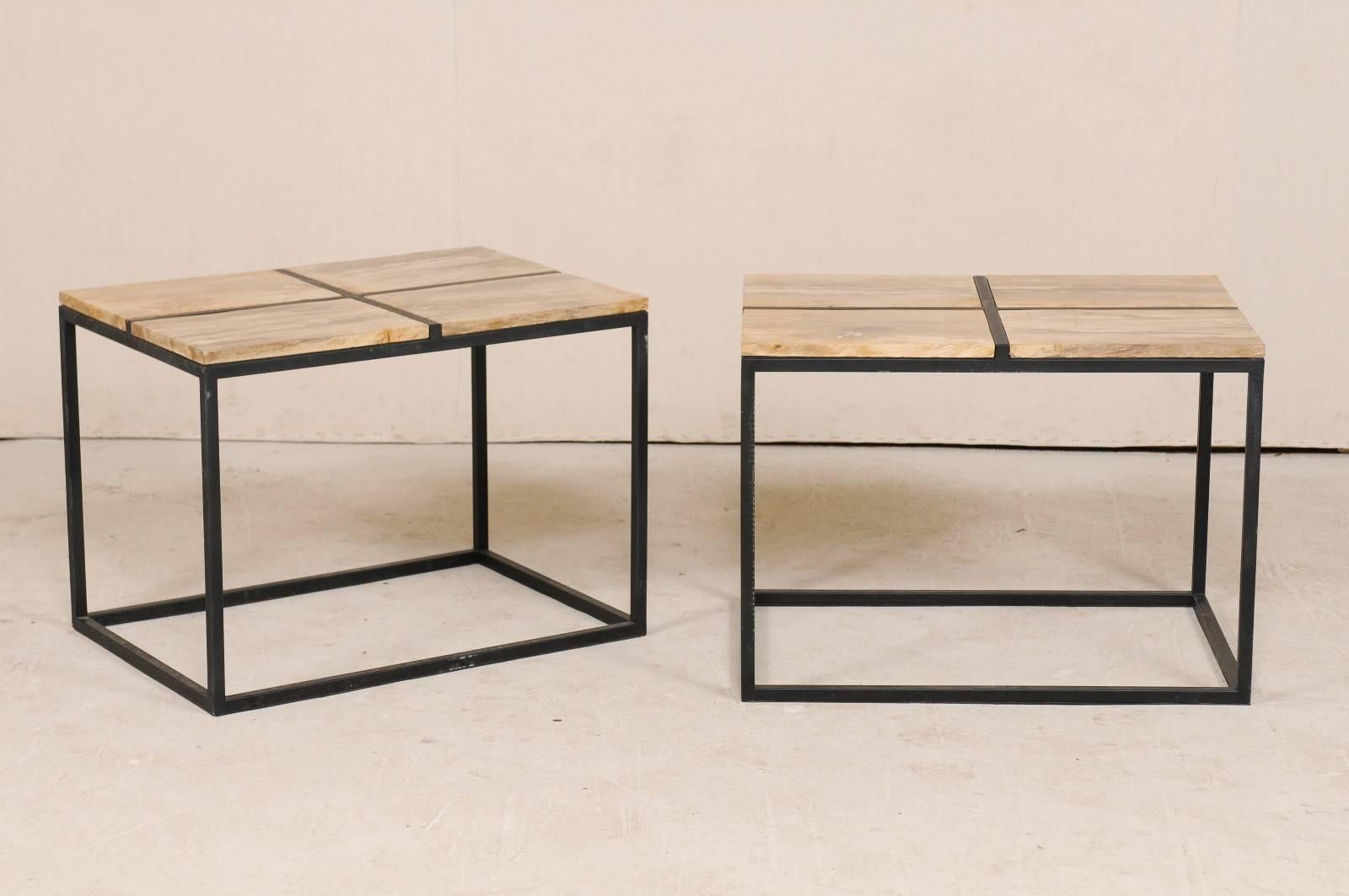A pair of modern style custom petrified wood top coffee or side tables. This pair of coffee tables each feature four rectangular-cut petrified wood pieces set into a frame, making an overall rectangular-shaped top. The petrified top consists of
